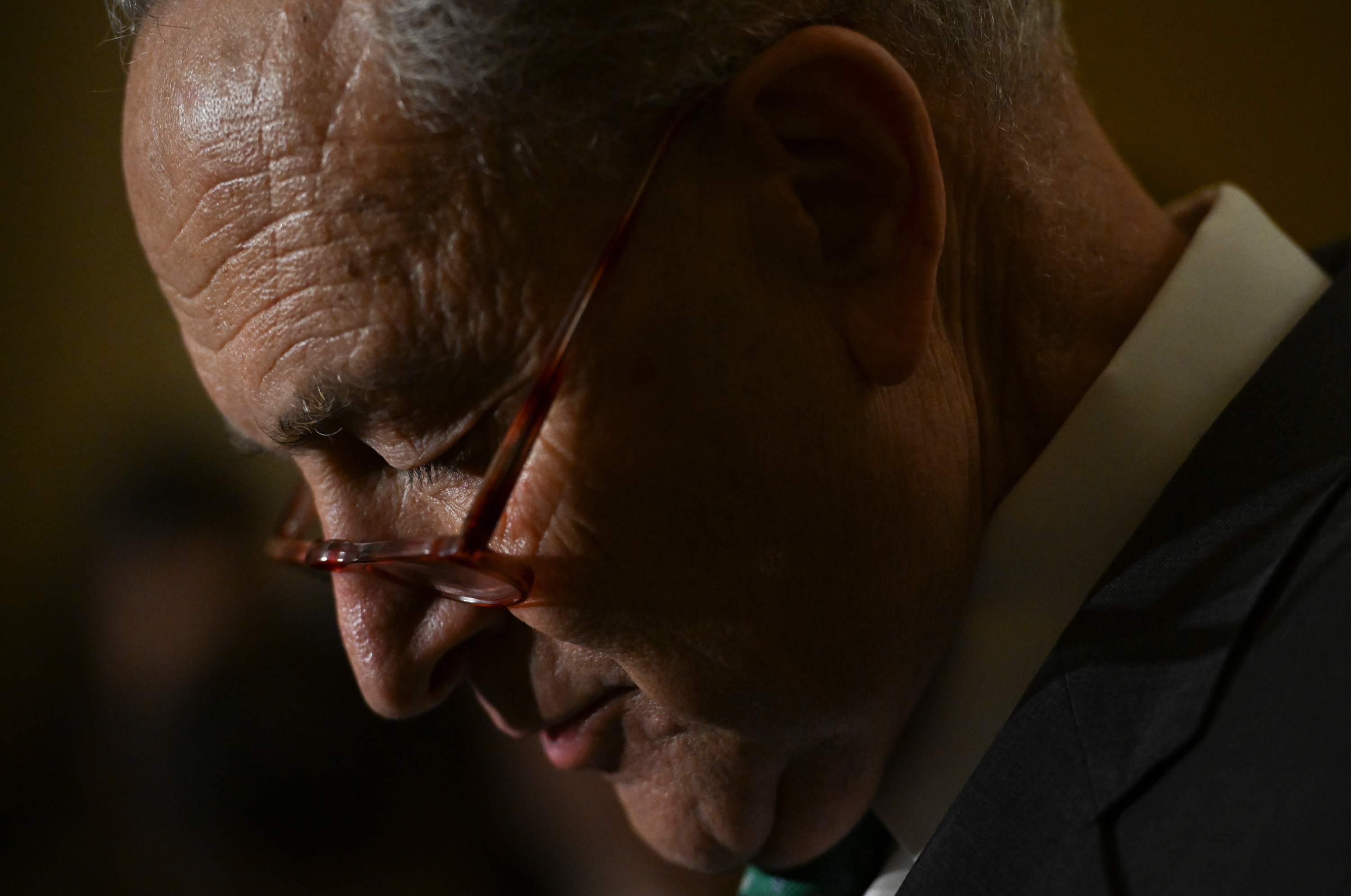 Senate Majority Leader Chuck Schumer pauses while speaking to the media at the Capitol, in Washington, DC on March 15.