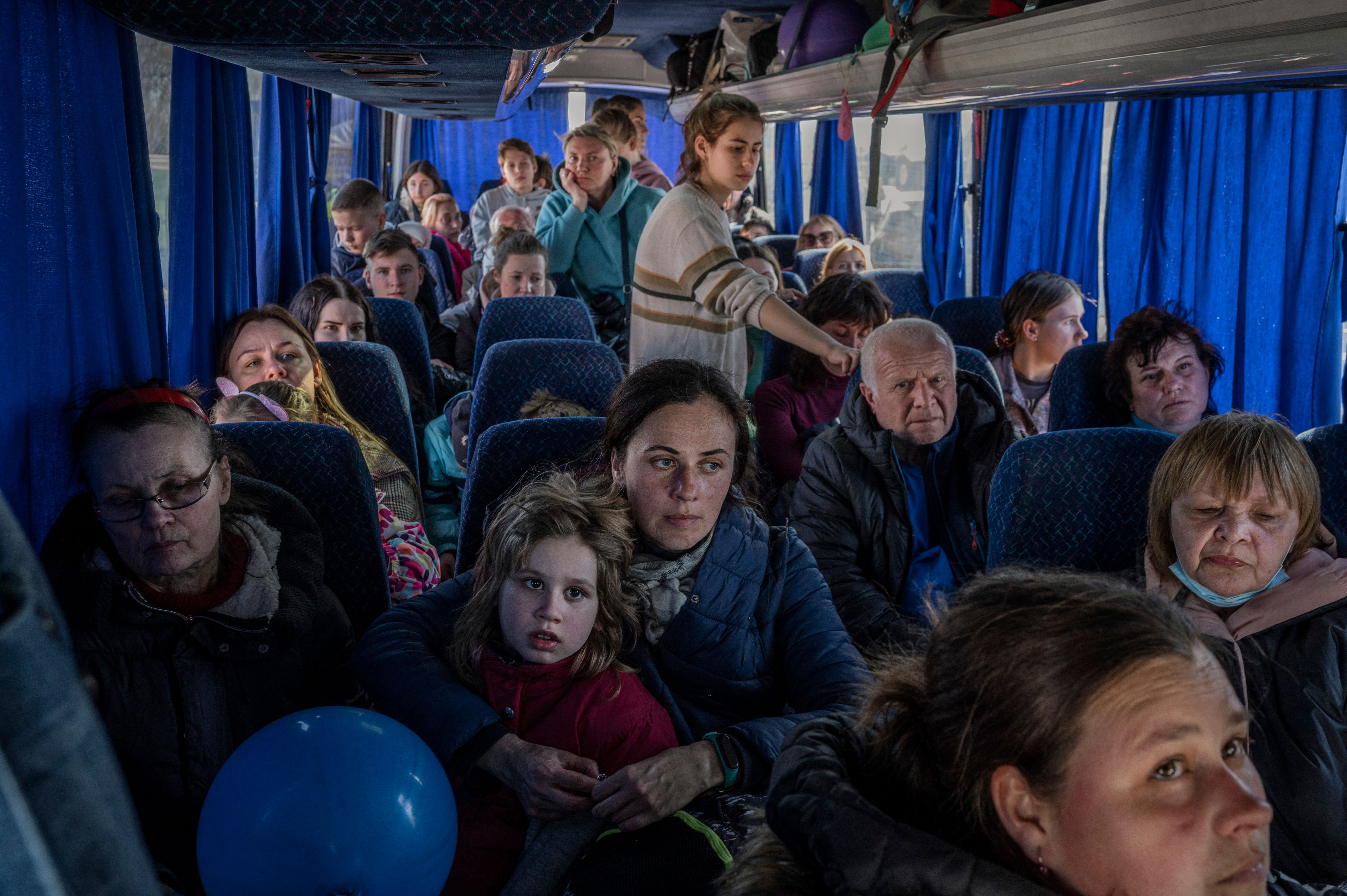 Ukrainian evacuees ride on a bus after crossing the Ukrainian border at the Medyka border crossing, southeastern Poland, on March 28.