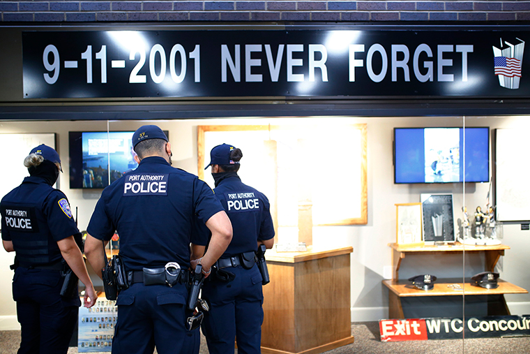 Port Authority Police officers look over a 9/11 memorial during a 9/11 memorial service and dedication of a display case at Port Authority Bus Terminal on September 09, 2021 in New York City. 
