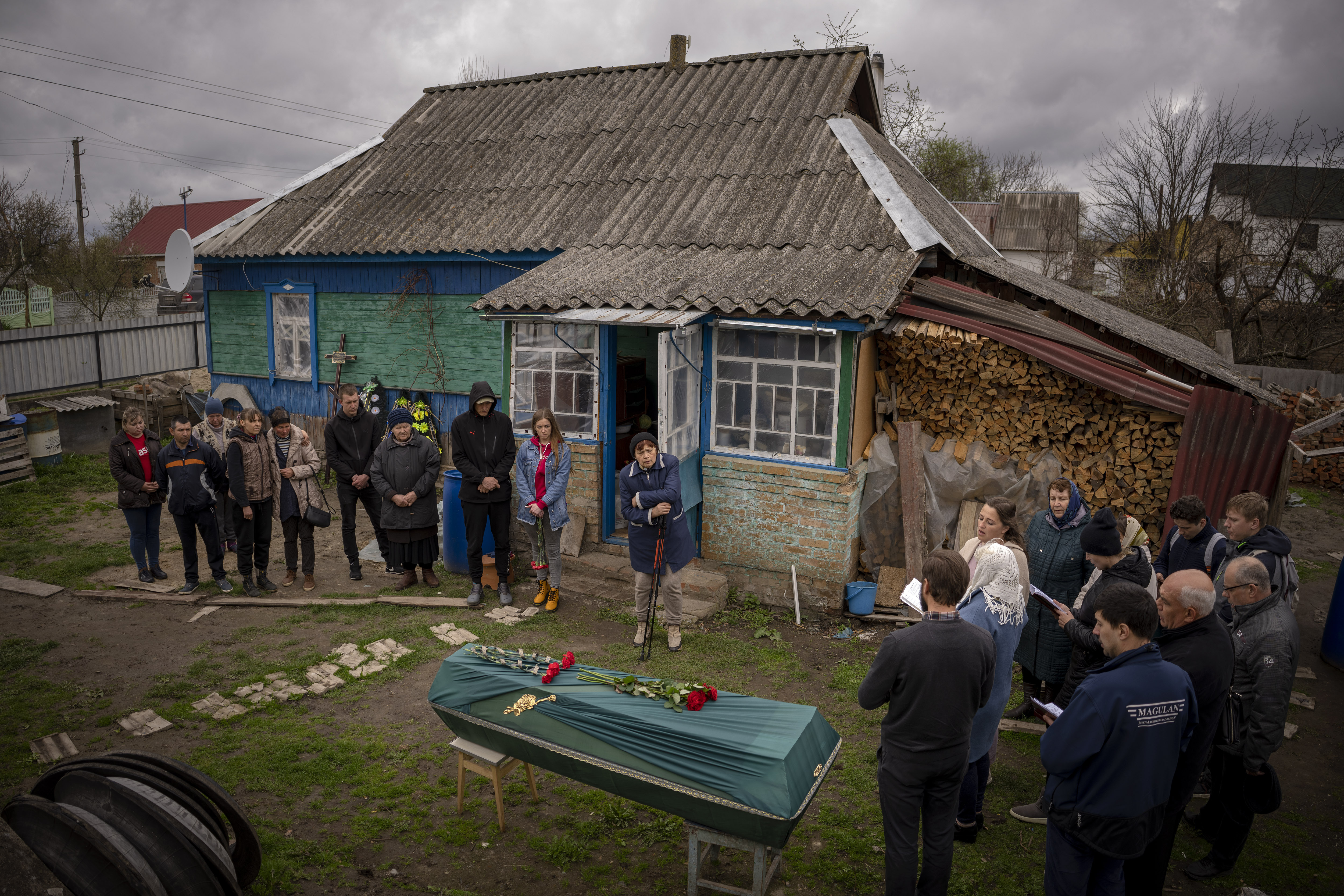Relatives of Mykola Moroz, 47, gather during a funeral service at his home at the Ozera village, near Bucha, Ukraine, on April 26.  
