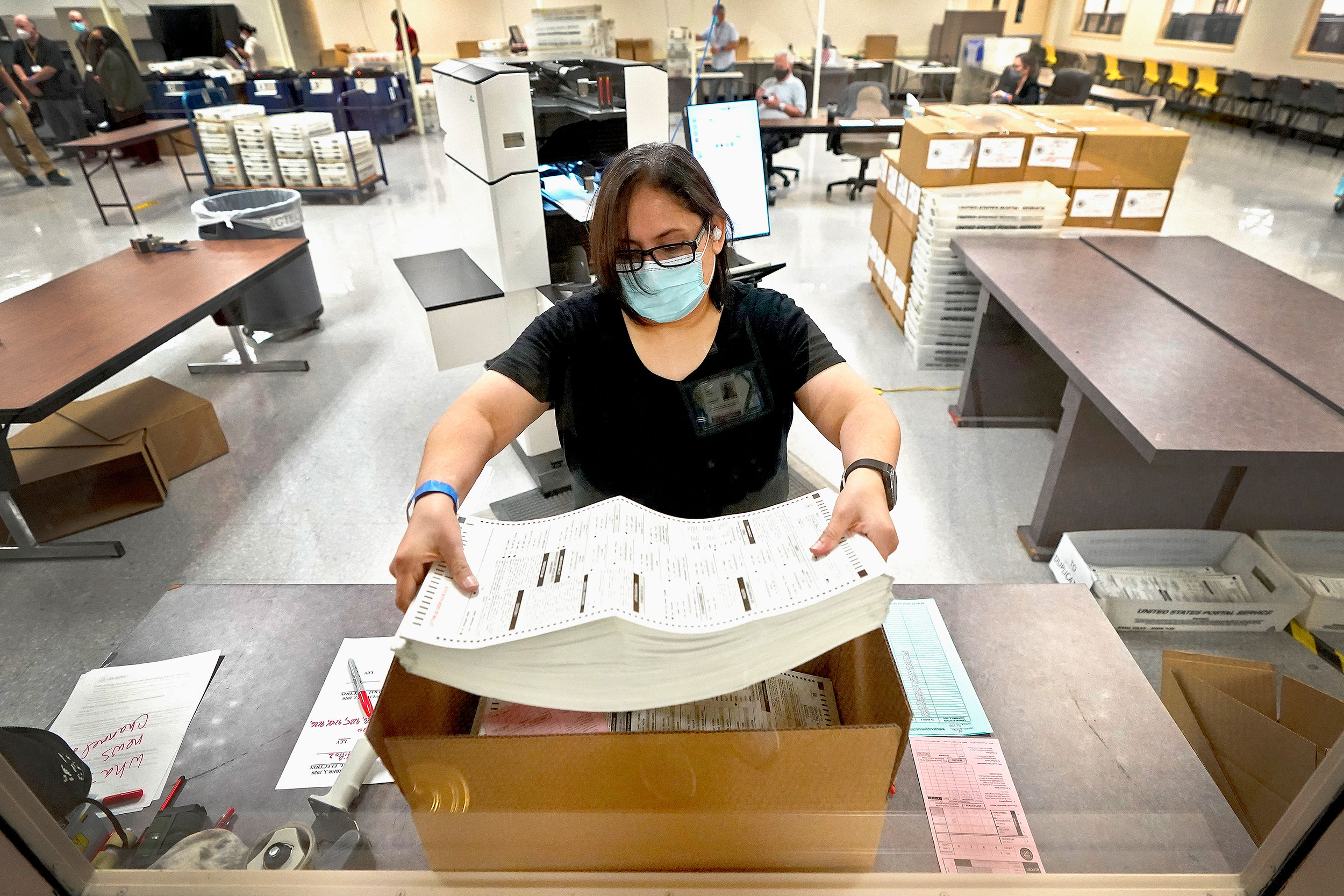 An election official counts ballots inside the Maricopa County Recorder's Office on November 6 in Phoenix, Arizona.
