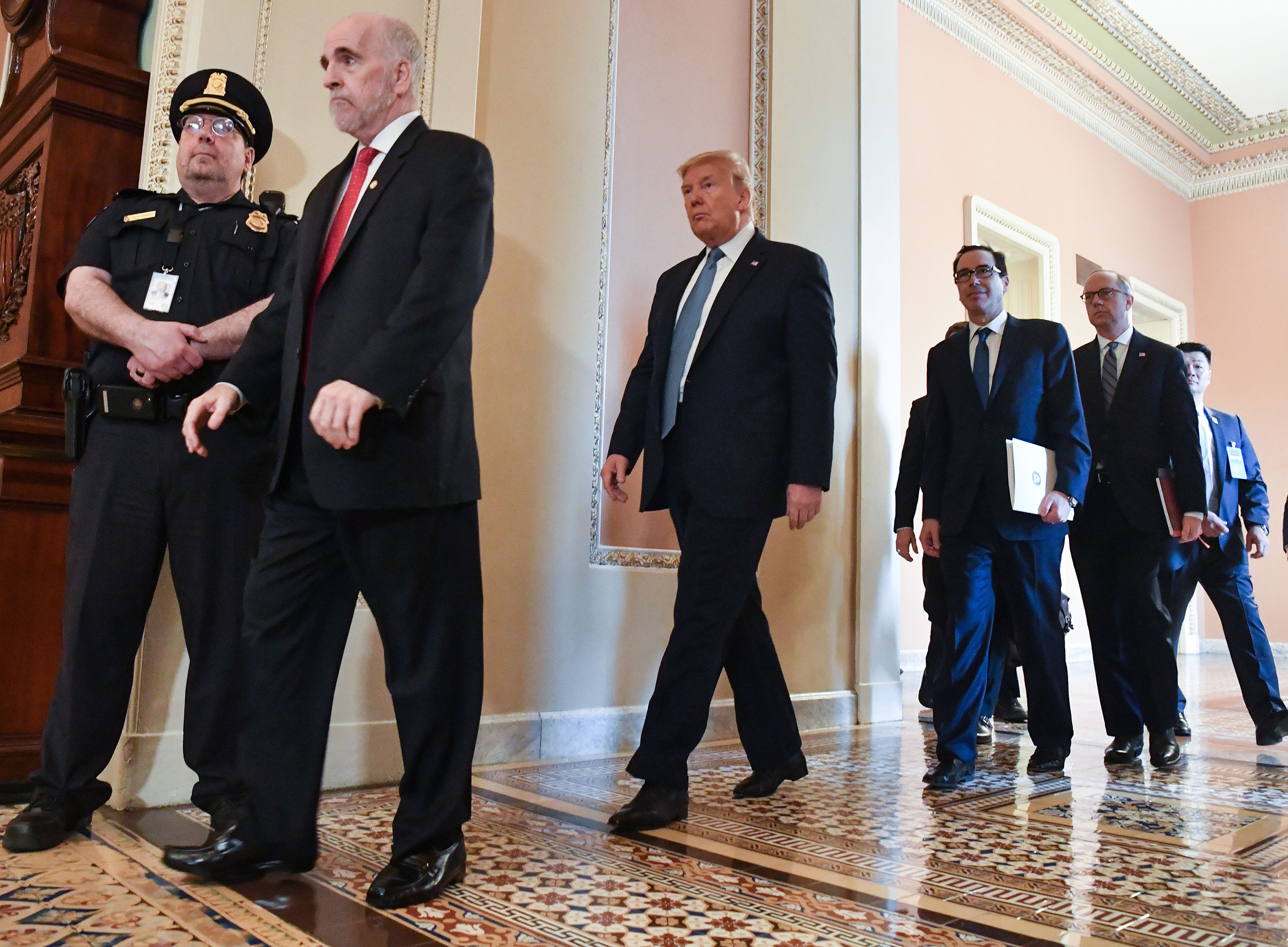 US President Donald Trump walks over to speak with reporters after meeting with Republican Senators on Capitol Hill in Washington, DC on March 10, 2020. 