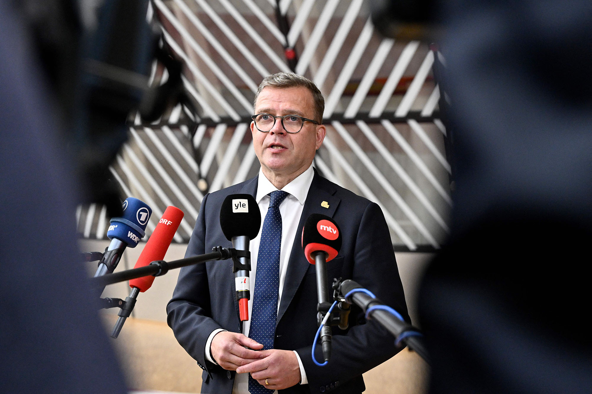 Finland's Prime Minister Petteri Orpo talks to the media as he arrives for a European Council Summit, at the EU headquarters in Brussels, Belgium, on June 29.