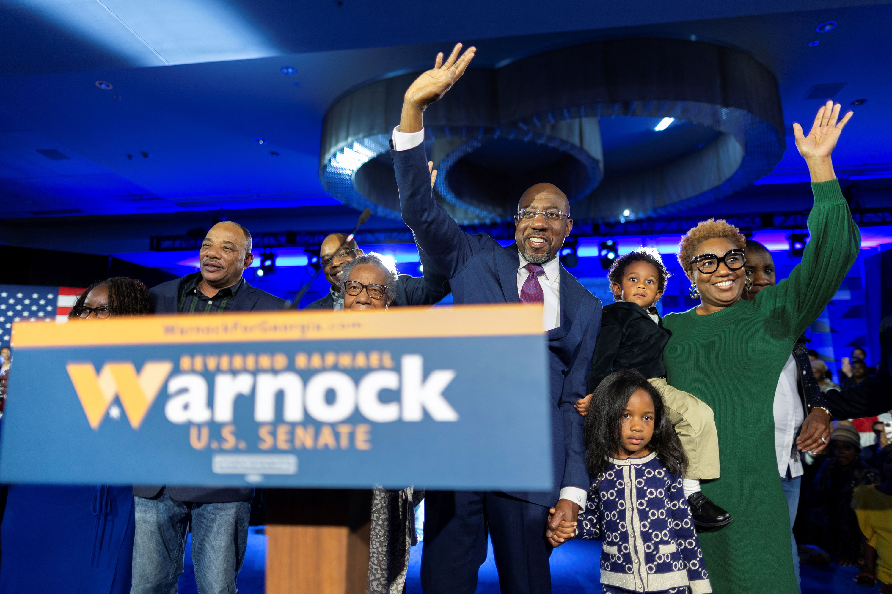 Sen. Raphael Warnock is joined on stage in Atlanta by his family after a projected win in the runoff election between Warnock and Herschel Walker.