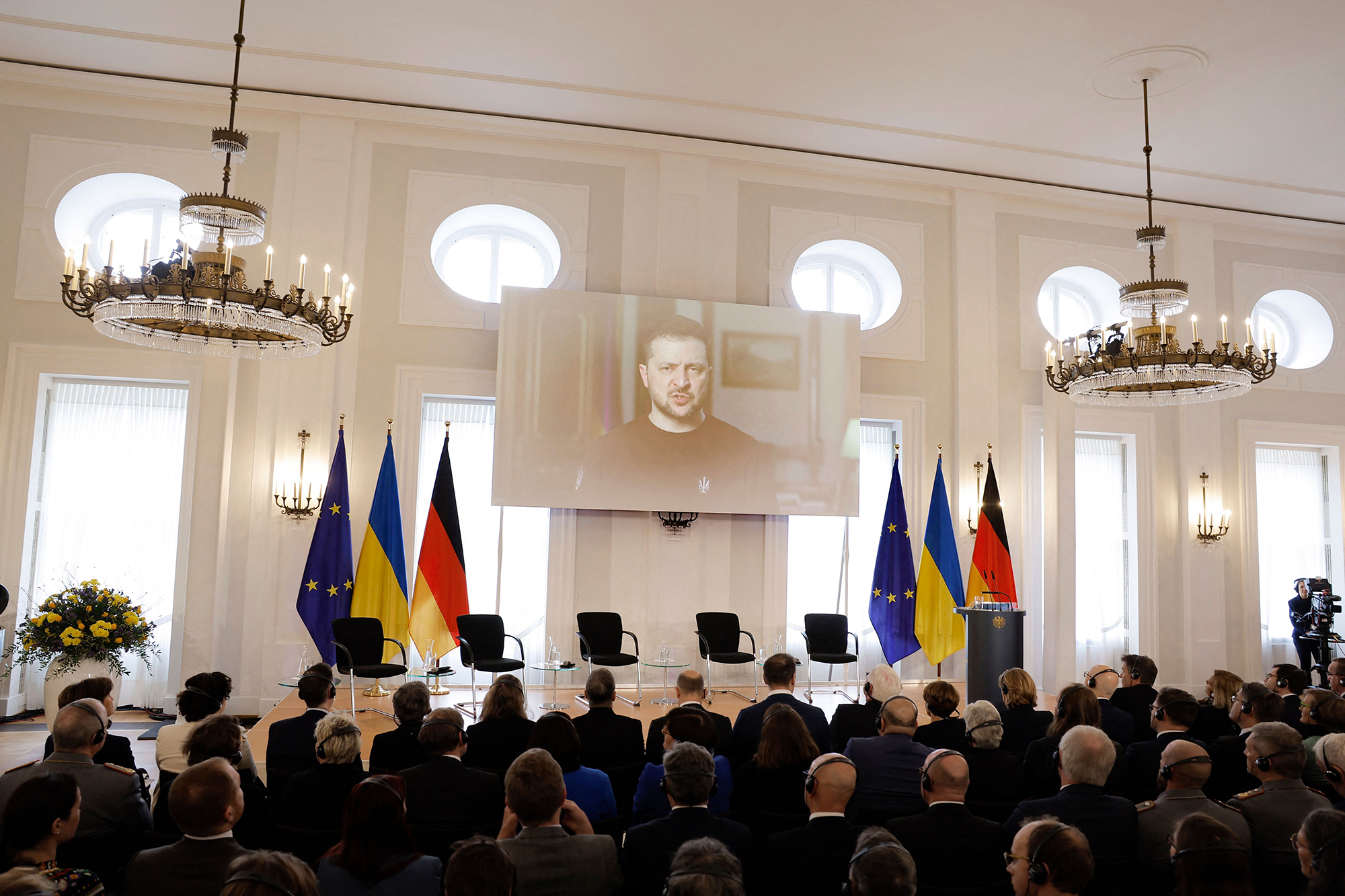 Ukrainian President Volodymyr Zelensky is seen on a screen as he addresses guests during a commemoration event on February 24, at the presidential Bellevue Palace in Berlin, Germany.