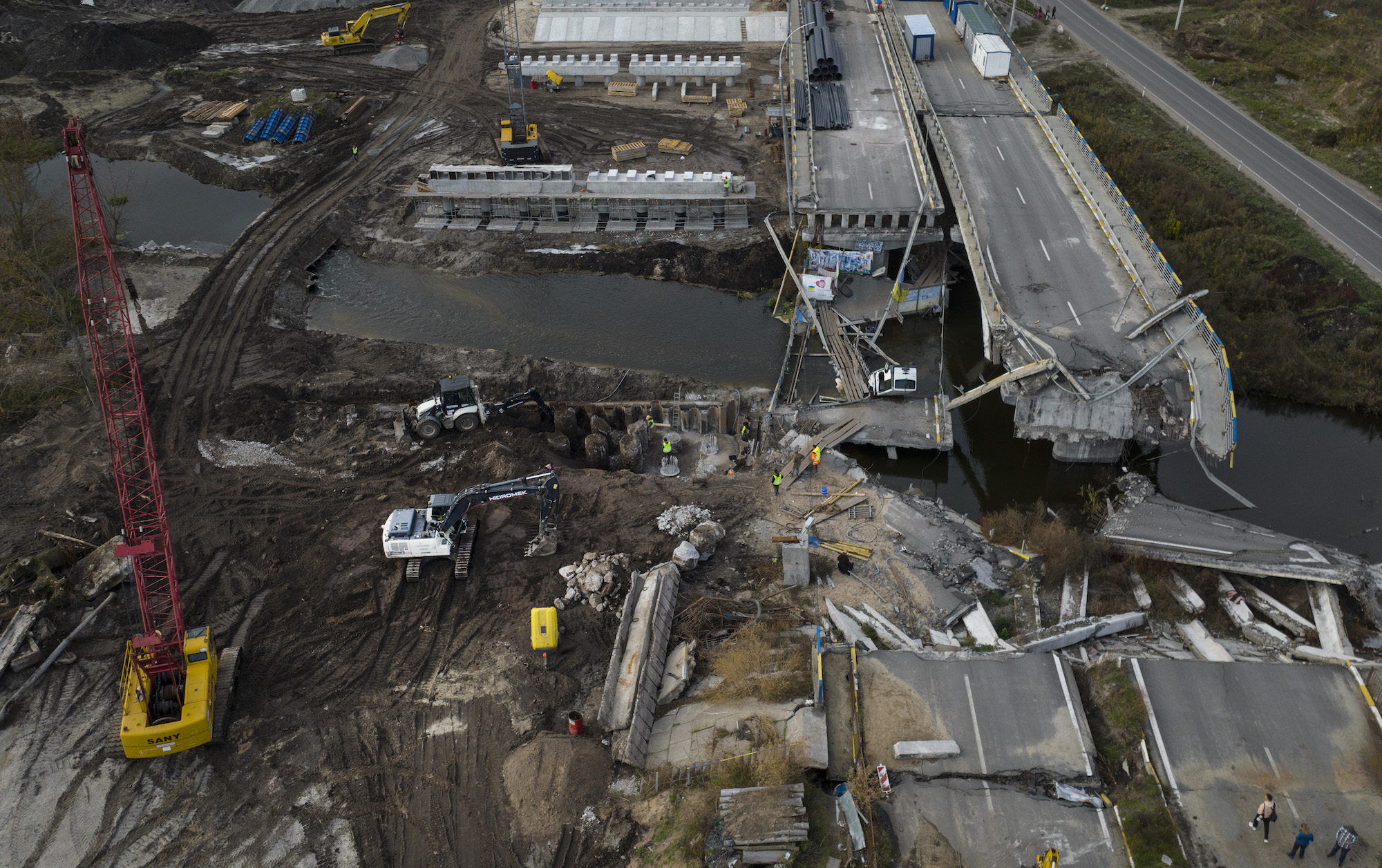 Construction is seen on a bridge that was destroyed to block the Russian advance toward the city of Irpin on October 28.