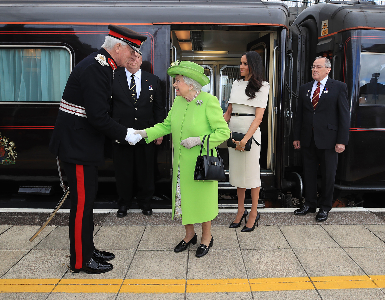 Queen Elizabeth II is greeted with Meghan, Duchess of Sussex as they arrive by Royal Train at Runcorn Station to open the new Mersey Gateway Bridge on June 14, 2018 in the town of Runcorn, Cheshire, England. 
