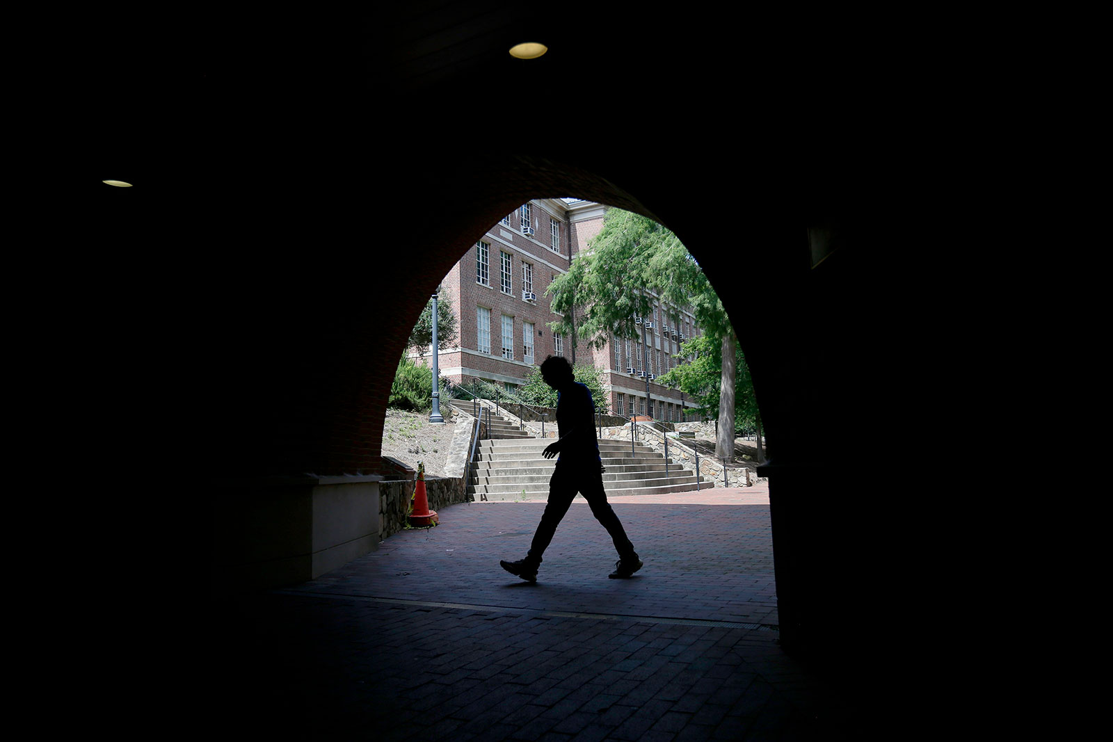 A pedestrian walks though a tunnel at the University of North Carolina in Chapel Hill in June.