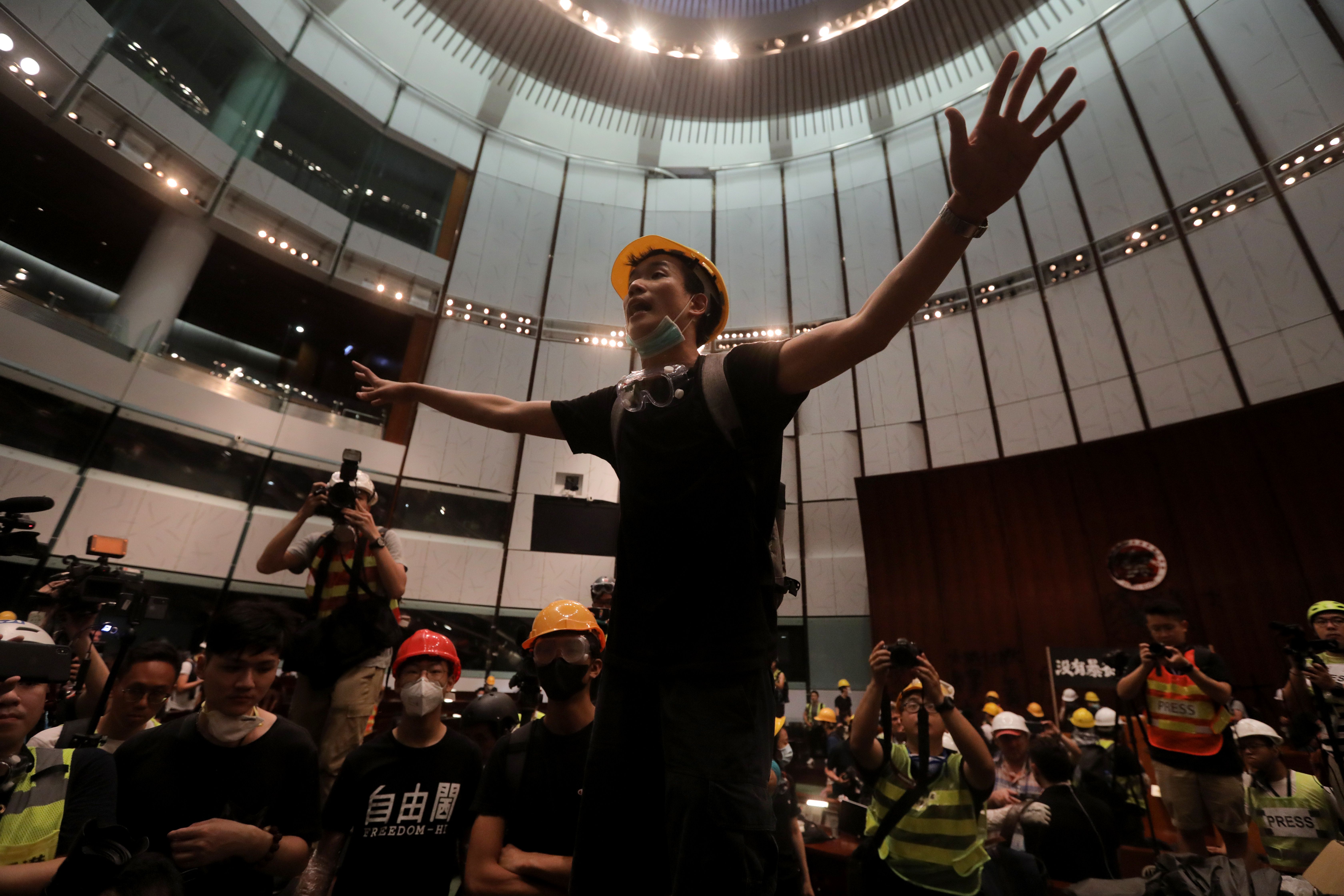 A protester gestures after they broke into the parliament chamber of the government headquarters in Hong Kong on July 1.