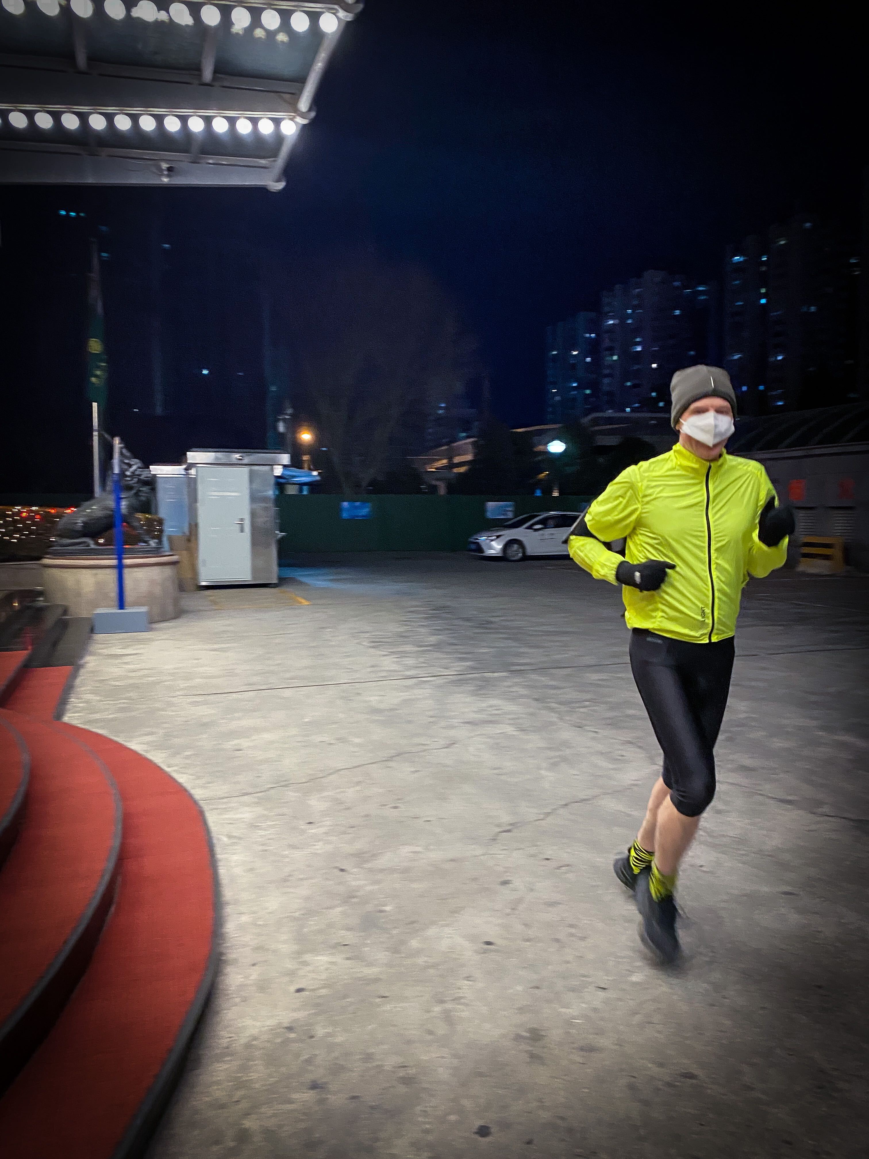 A man jogs inside the closed loop of the Beijing Olympic Village