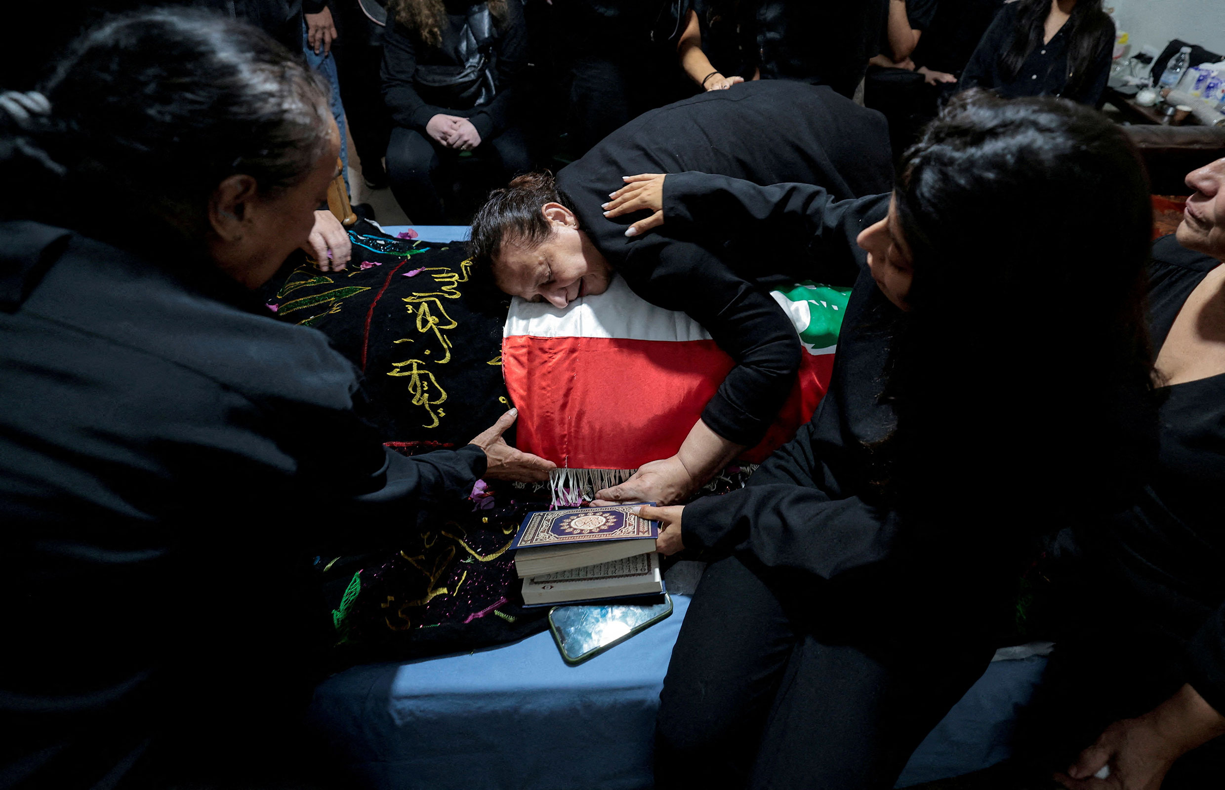 Fatma Kanso, the mother of Issam Abdallah, a Lebanese national and Reuters videojournalist who was killed in southern Lebanon, mourns over her son's body during his funeral in his home town of Al Khiyam, Lebanon, on October 14. 