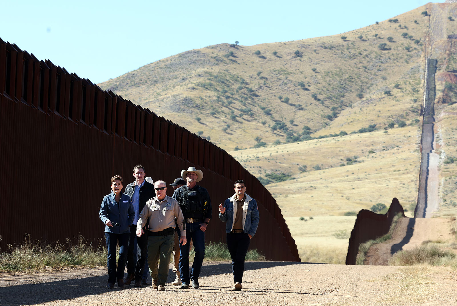 Kari Lake, left, Blake Masters, second left, Abraham Hamadeh, right, talk with Cochise County Sheriff Mark Dannels as they tour the US-Mexico border with law enforcement in Sierra Vista, Arizona on Friday.