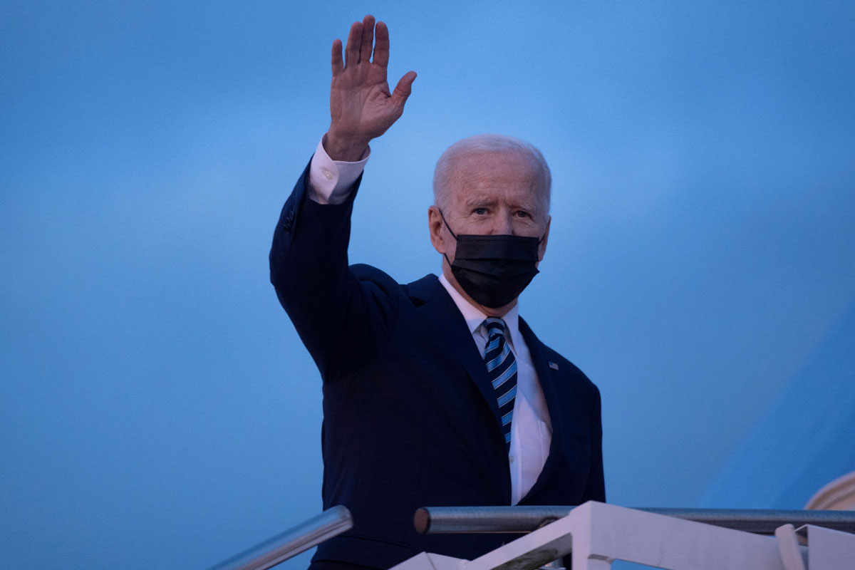 US President Joe Biden waves as he boards Air Force One at Royal Air Force Mildenhall on June 9 en route to Cornwall Airport in Newquay, England.