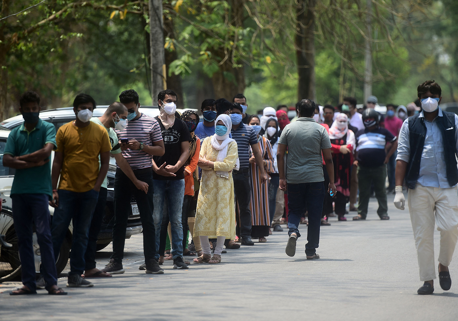 People line up while waiting to receive a dose of the Covishield coronavirus vaccine, outside the Moti Lal Nehru Medical College in Allahabad on May 1.