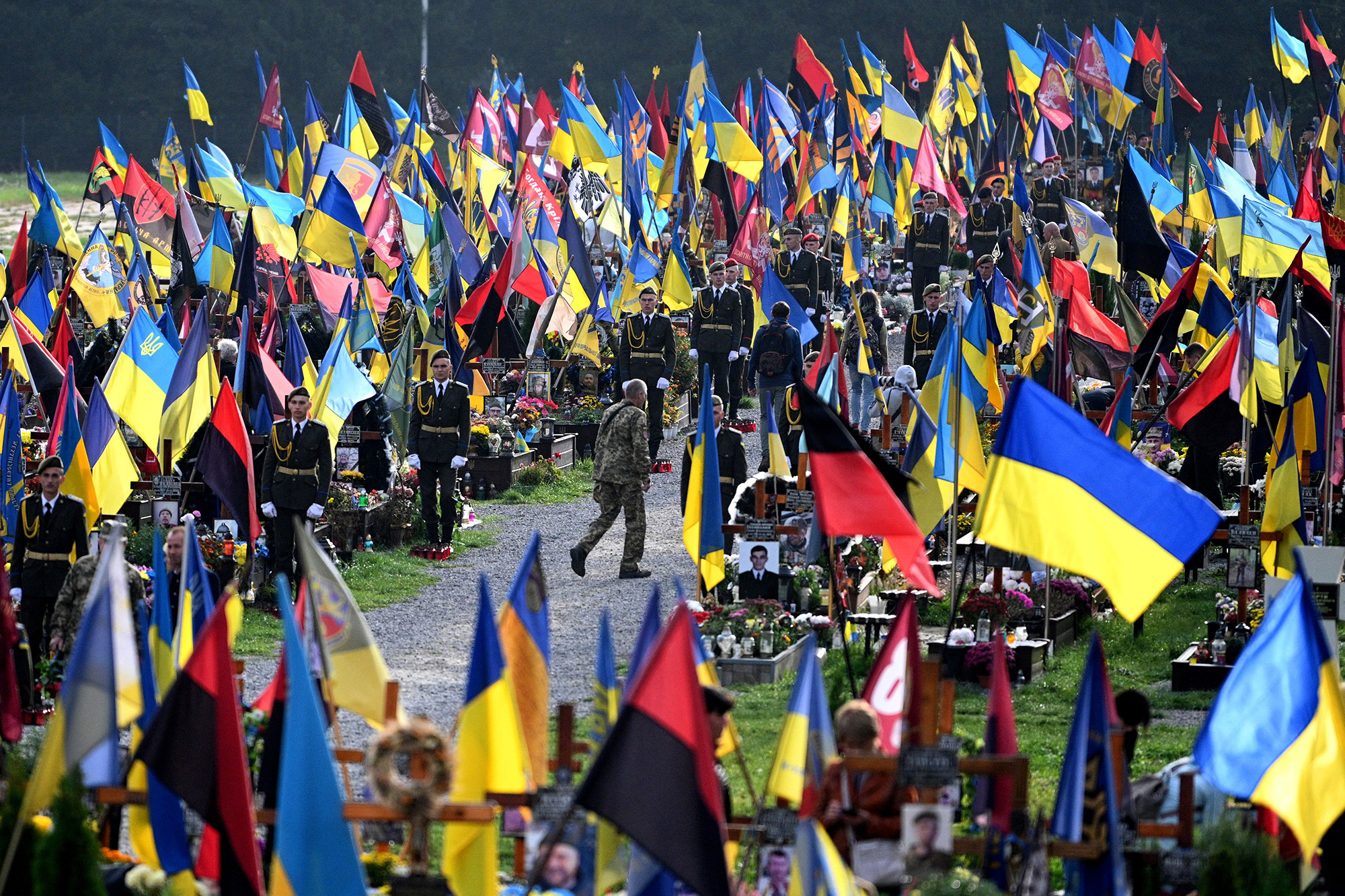 People visit the graves of fallen Ukrainian soldiers at Lychakiv Cemetery in Lviv on October 1.