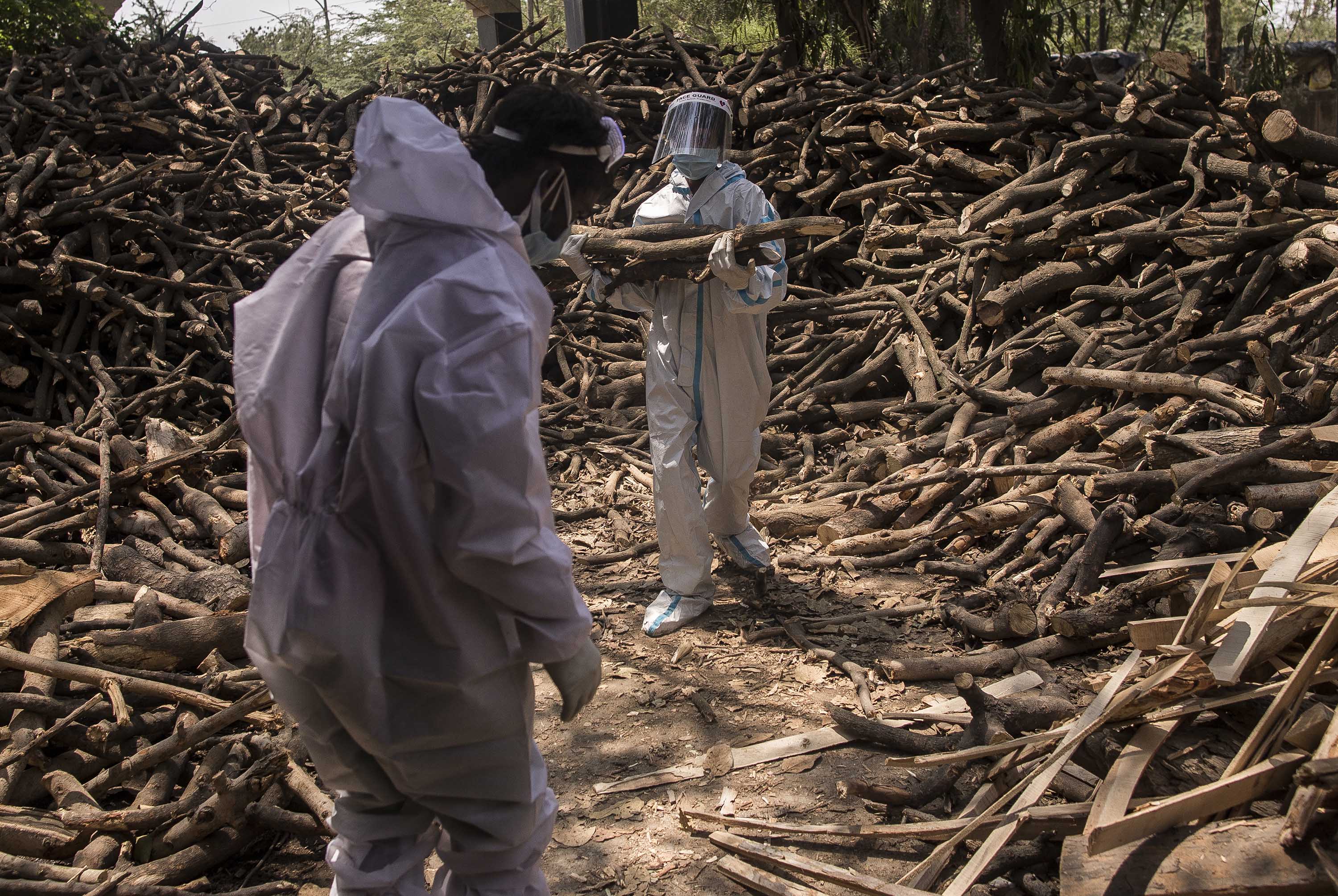 Workers sort logs of wood to be used on funeral pyres for people who died of Covid-19, at a crematorium on the outskirts of New Delhi, India, on April 22.