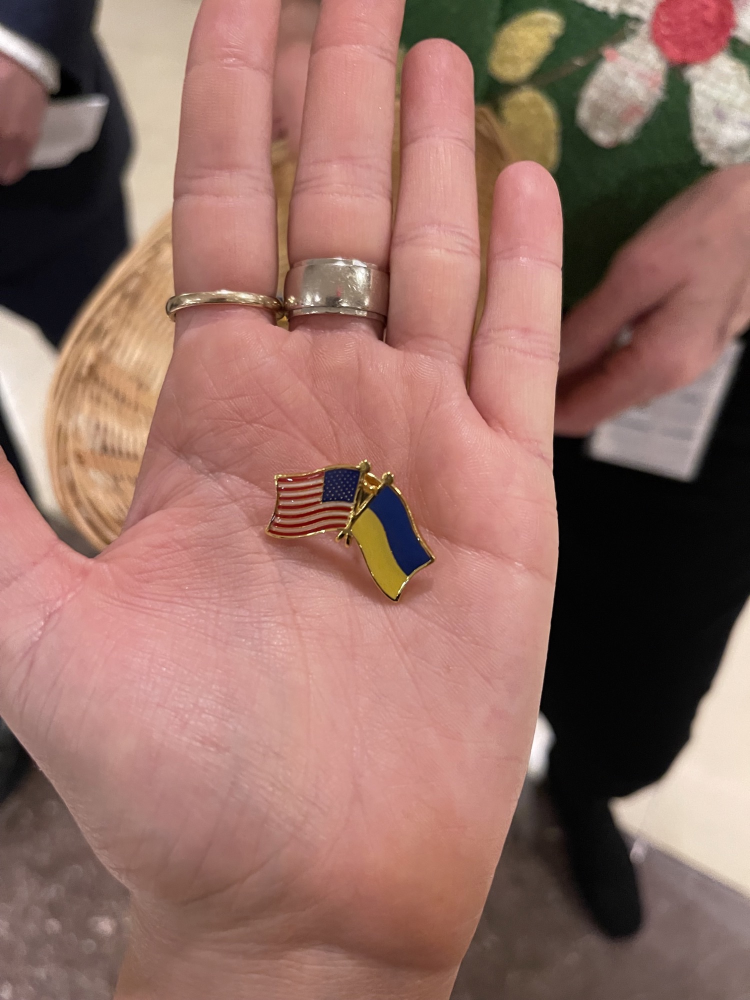 Capitol staffer handed out Ukraine-US flag pins to lawmakers attending Zelensky's address at the Capitol on March 16.