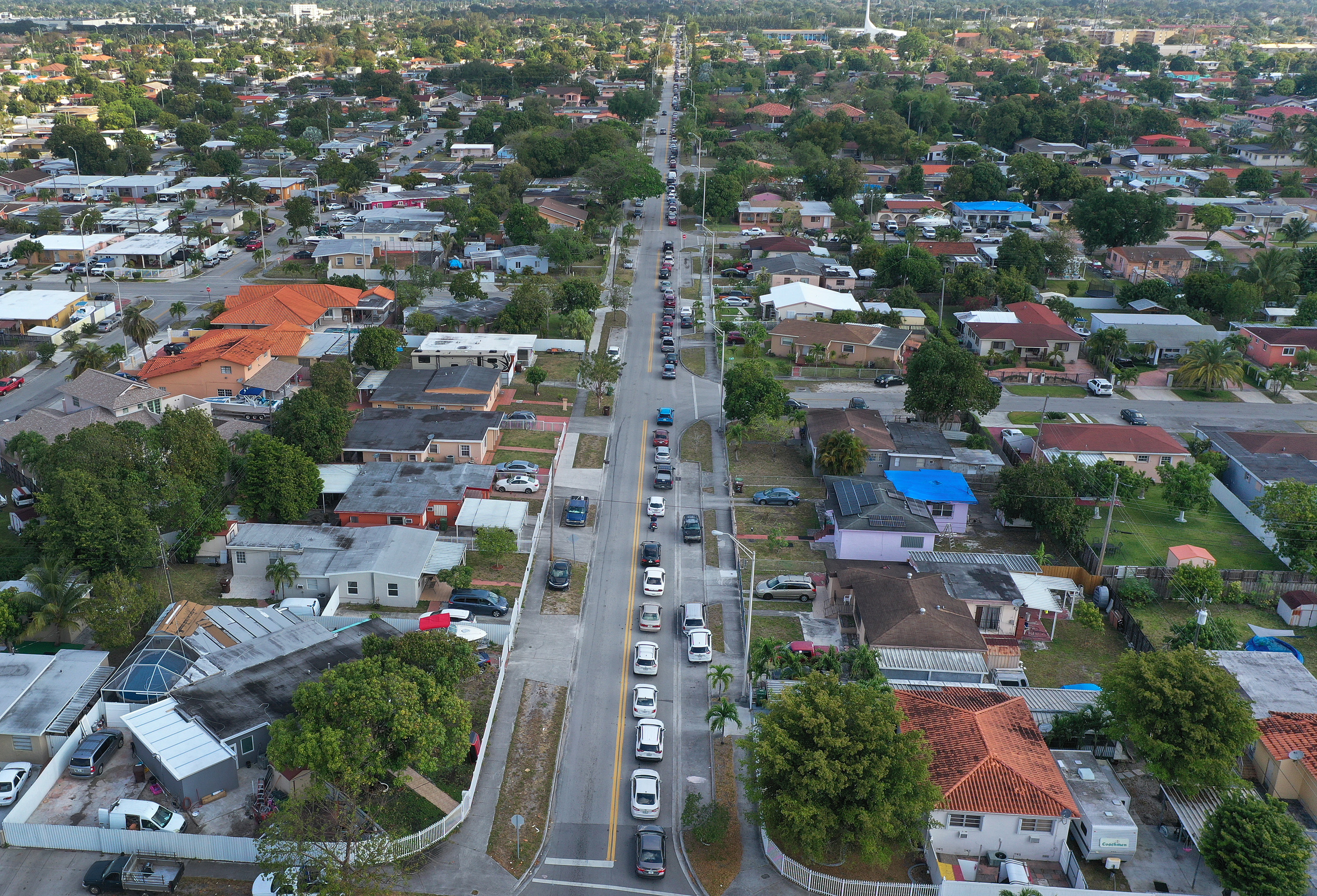 An aerial view from a drone shows vehicles lining up to receive unemployment applications in Hialeah, Florida, on April 8. The applications were being distributed by City of Hialeah employees in front of the John F. Kennedy Library.