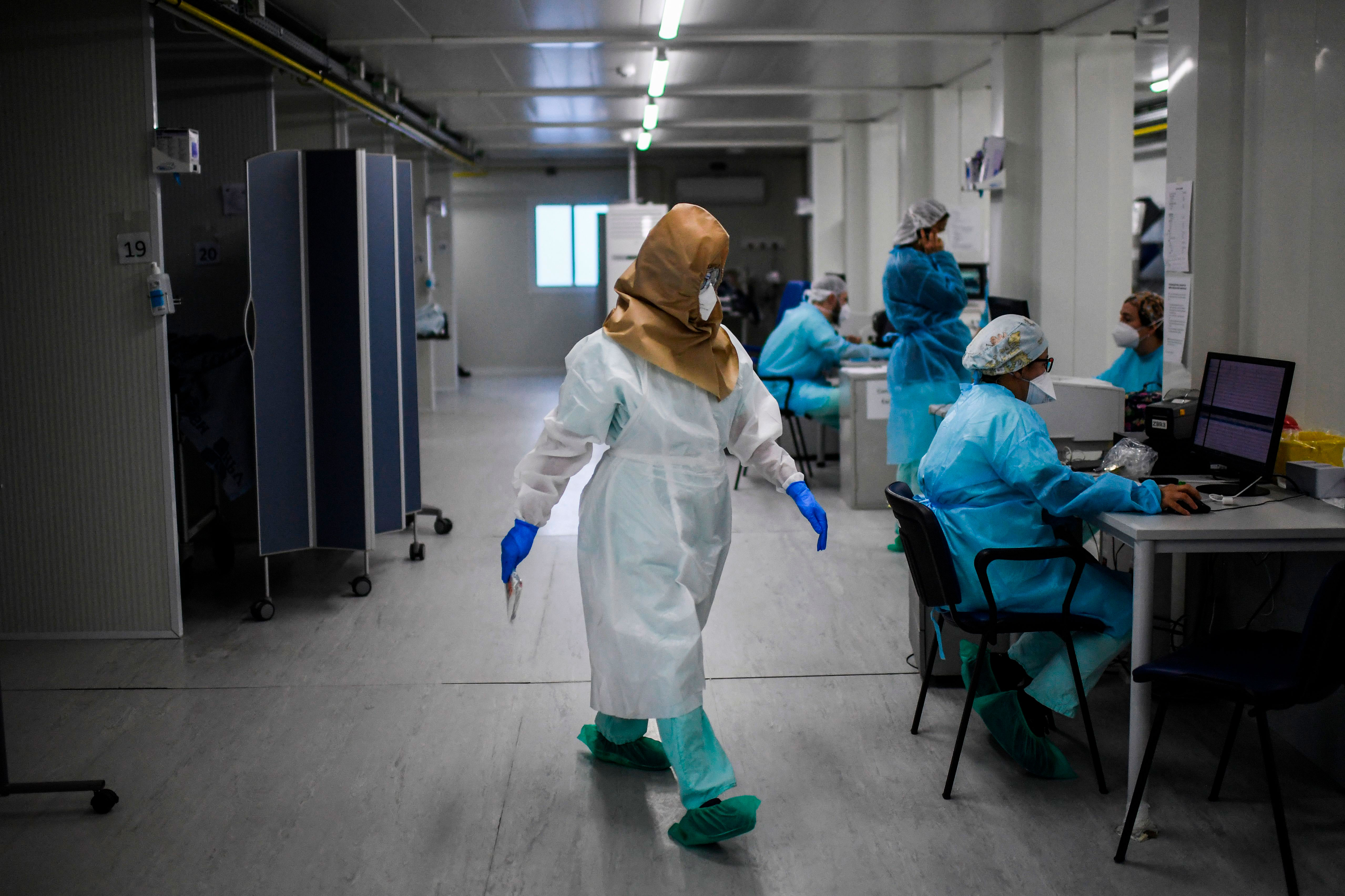 A health care worker walks in the Covid-19 emergency room of Santa Maria hospital in Lisbon, Portugal, on January 11.