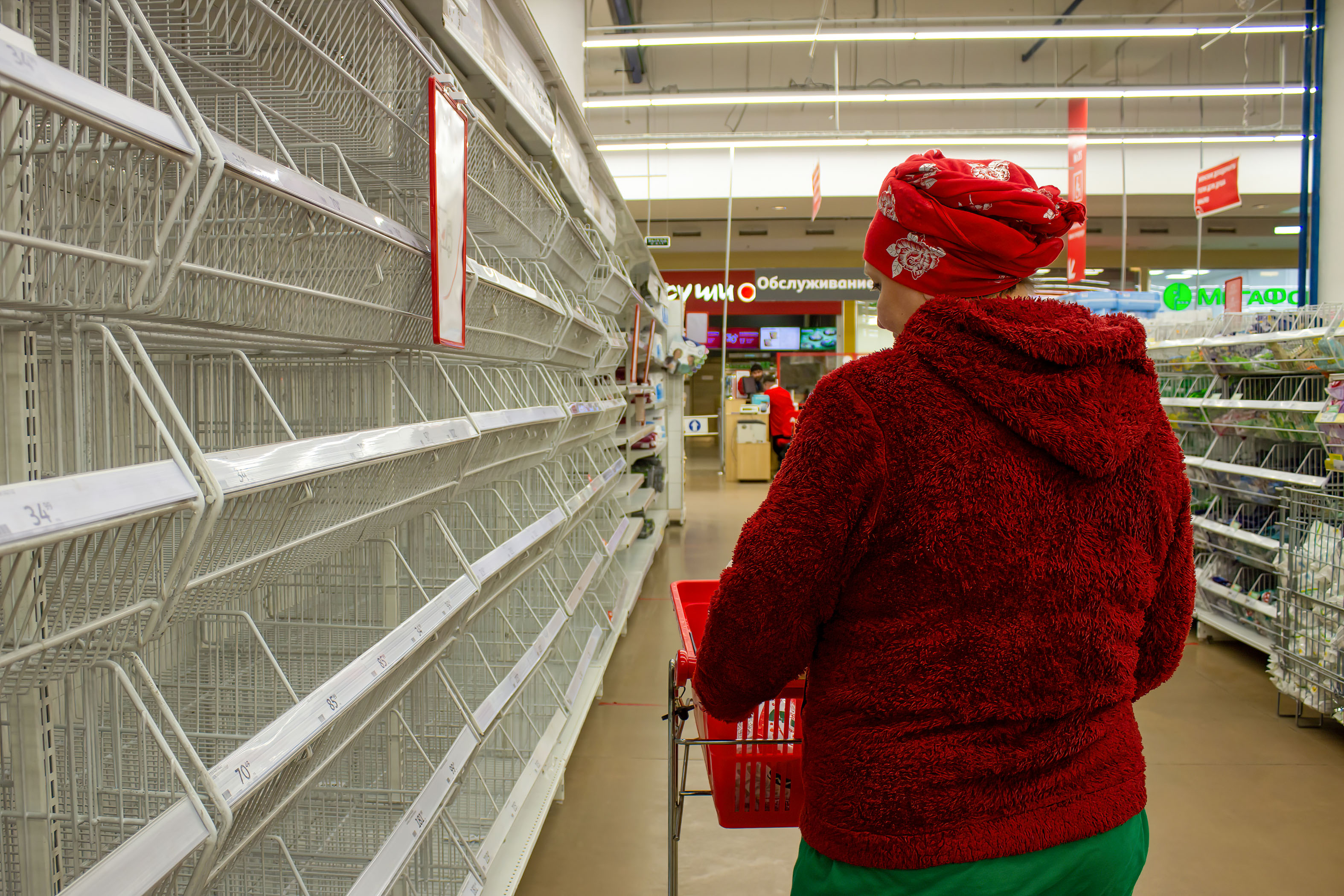 A woman looks at empty shelves in a supermarket in Moscow, Russia, on March 23.