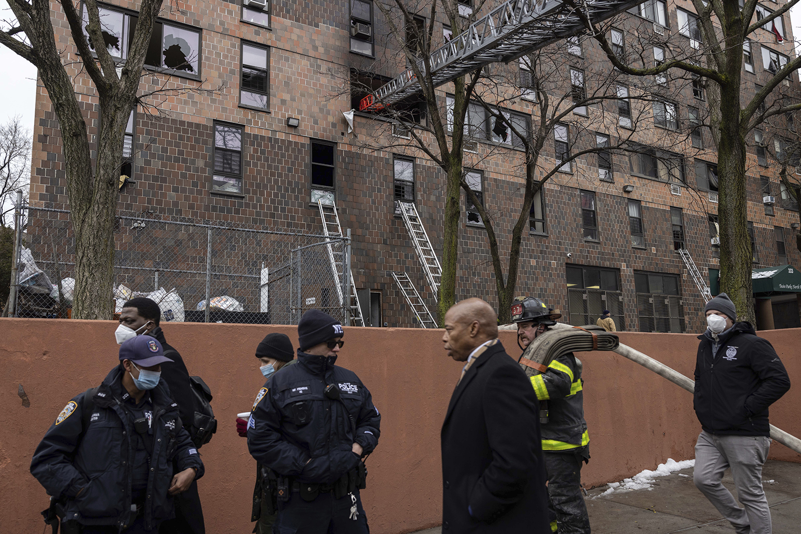 New York City Mayor Eric Adams, third right, at the scene where a deadly fire occurred in the Bronx on Sunday. 