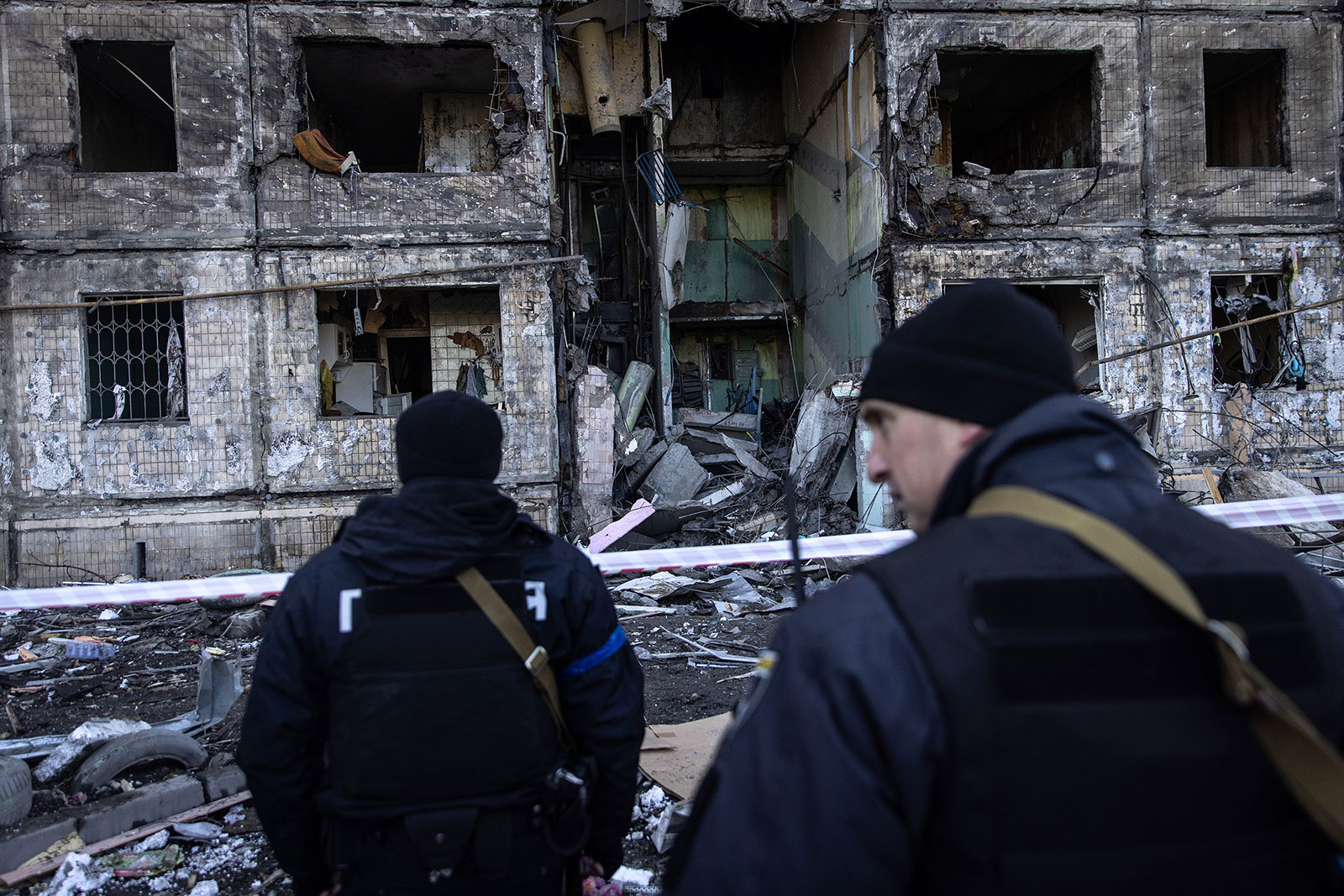 Police officers stand in front of an apartment block in Kyiv, Ukraine, that was hit by shelling on March 14.