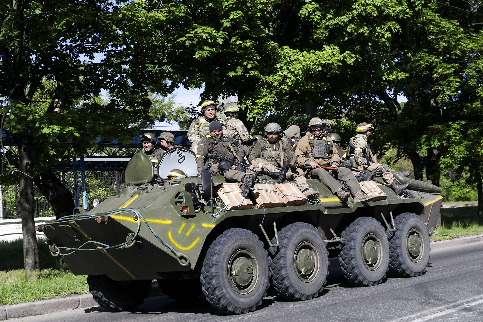 Ukrainian service personnel ride on top of an armoured vehicle amid Russia's attack on Ukraine, in Kharkiv, Ukraine, on May 16.