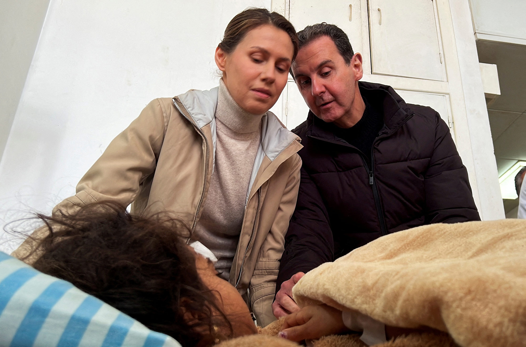 Syrian President Bashar al-Assad and his wife Asma visit an injured girl at Tishreen University Hospital, in Latakia, Syria, on February 11. 