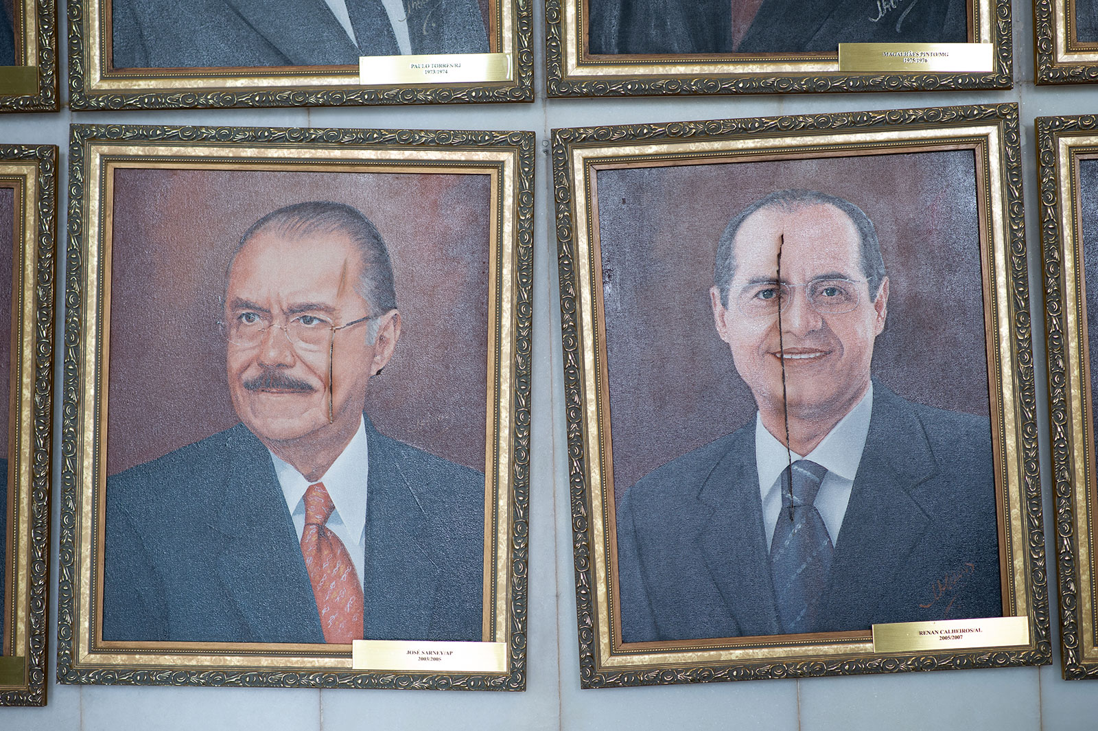Damaged portraits labeled with the names of Brazilian politicians José Sarney and Renan Calheiros, both former presidents of the Senate, are seen at the Brazilian National Congress following a riot the previous day.