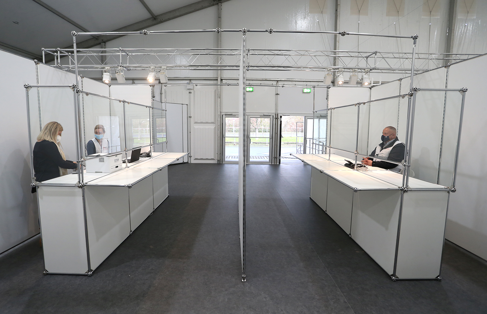 Members of aid organizations stand in the entrance area of the joint vaccination center of the city and district of Würzburg, Germany on December 16.