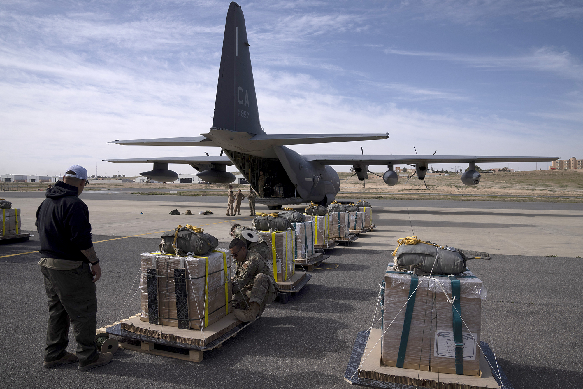 Members of the U.S. Air Force check the containers before loading an airplane with humanitarian aid to be dropped over Gaza at an area in Jordan, on March 14.