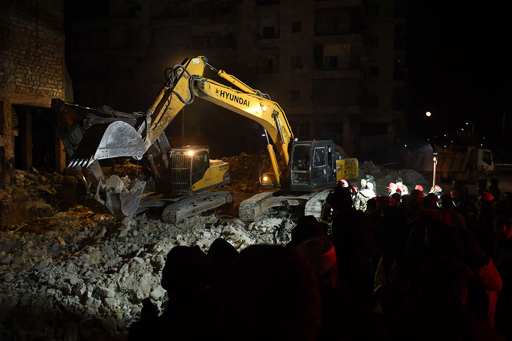 Rescuers search through the rubble of a collapsed building in Aleppo, Syria on February 8.