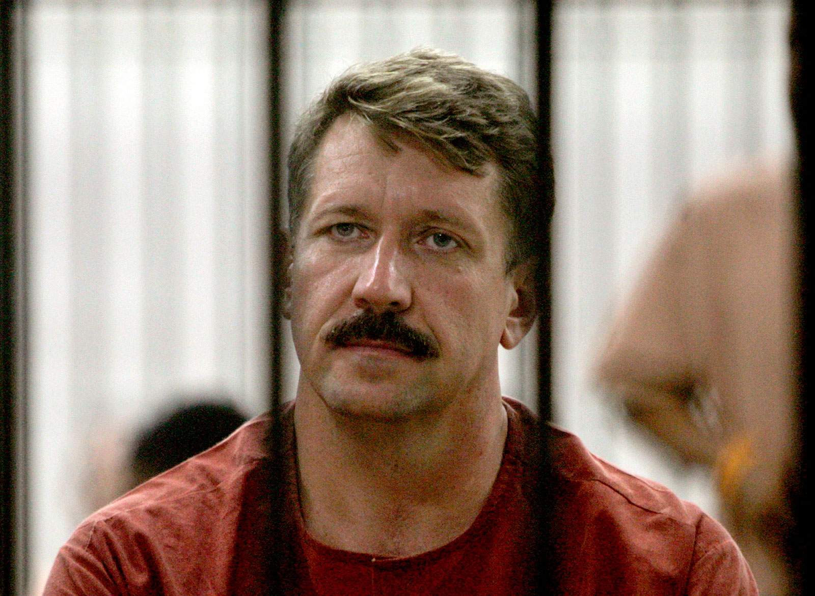 Viktor Bout looks out from inside a detention center in Bangkok, Thailand, in 2009. 