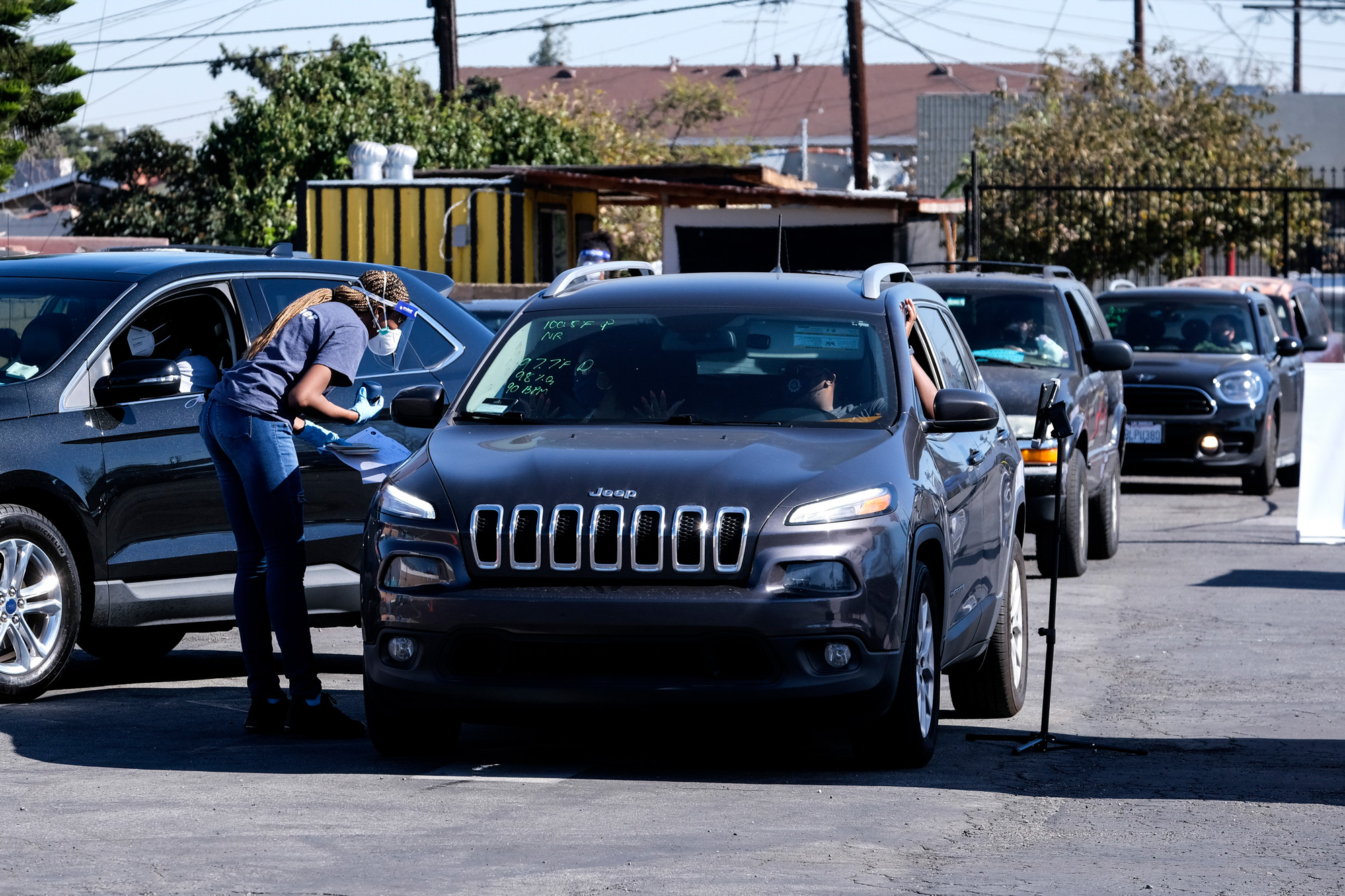 Motorists wait in line for a rapid COVID-19 antibody and PCR test at the Southside Church of Christ in Los Angeles on January 18.