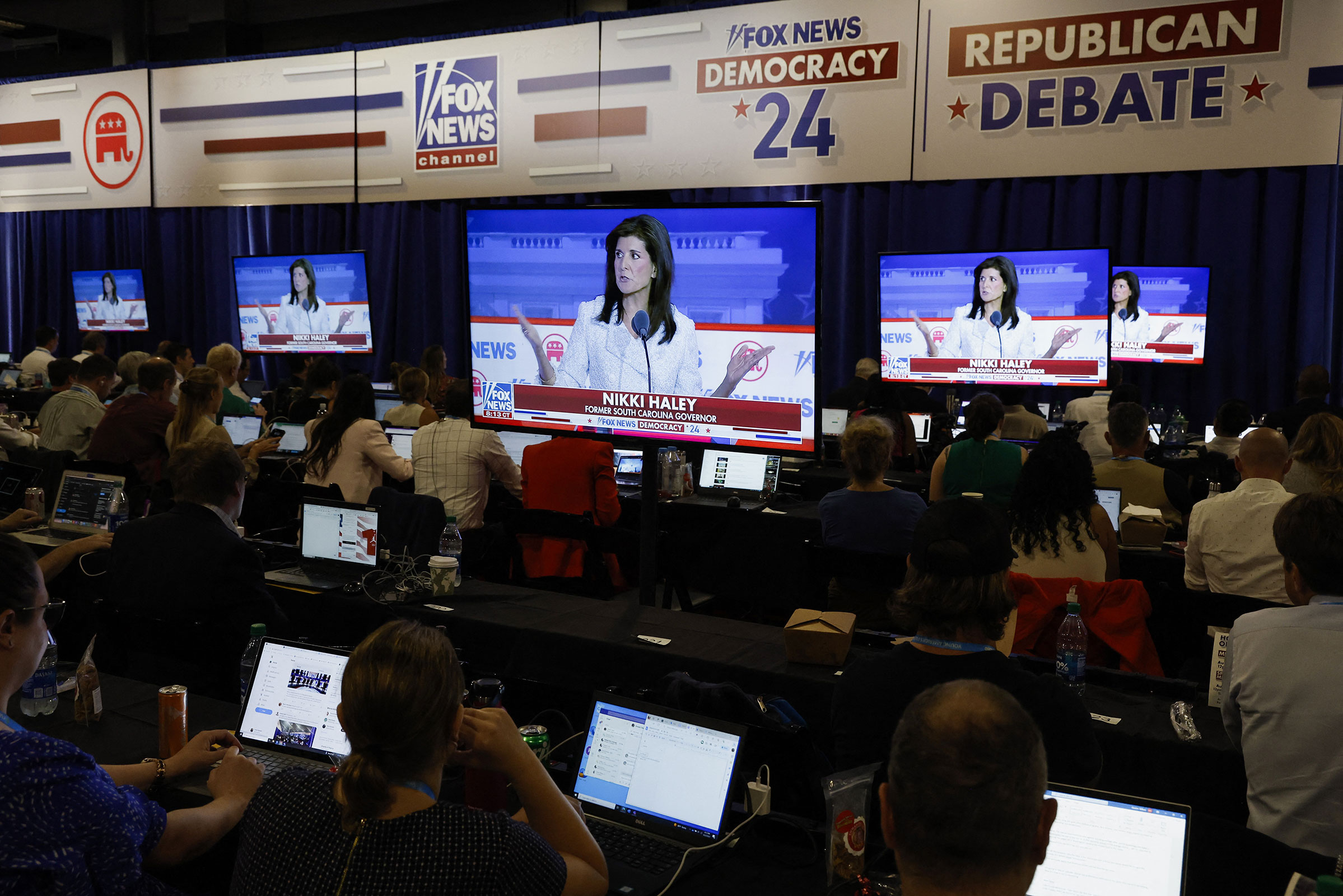 Former South Carolina Gov. Nikki Haley is seen debating on screens in the media filing center on Wednesday.