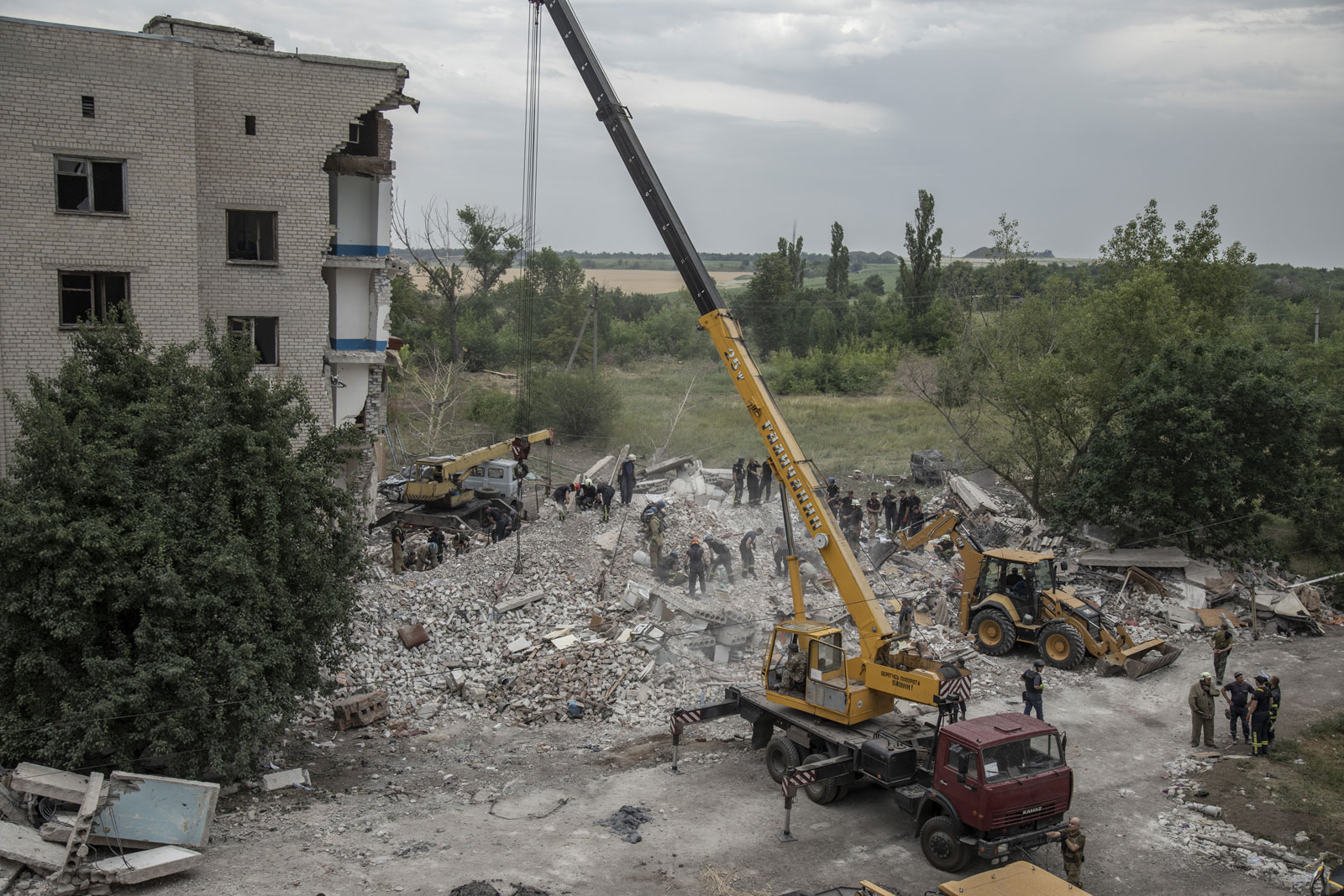 Rescue personal and firefighters look for survivors after a building was partially destroyed by a strike in the town of Chasiv Yar, in the Donetsk region, on Saturday.