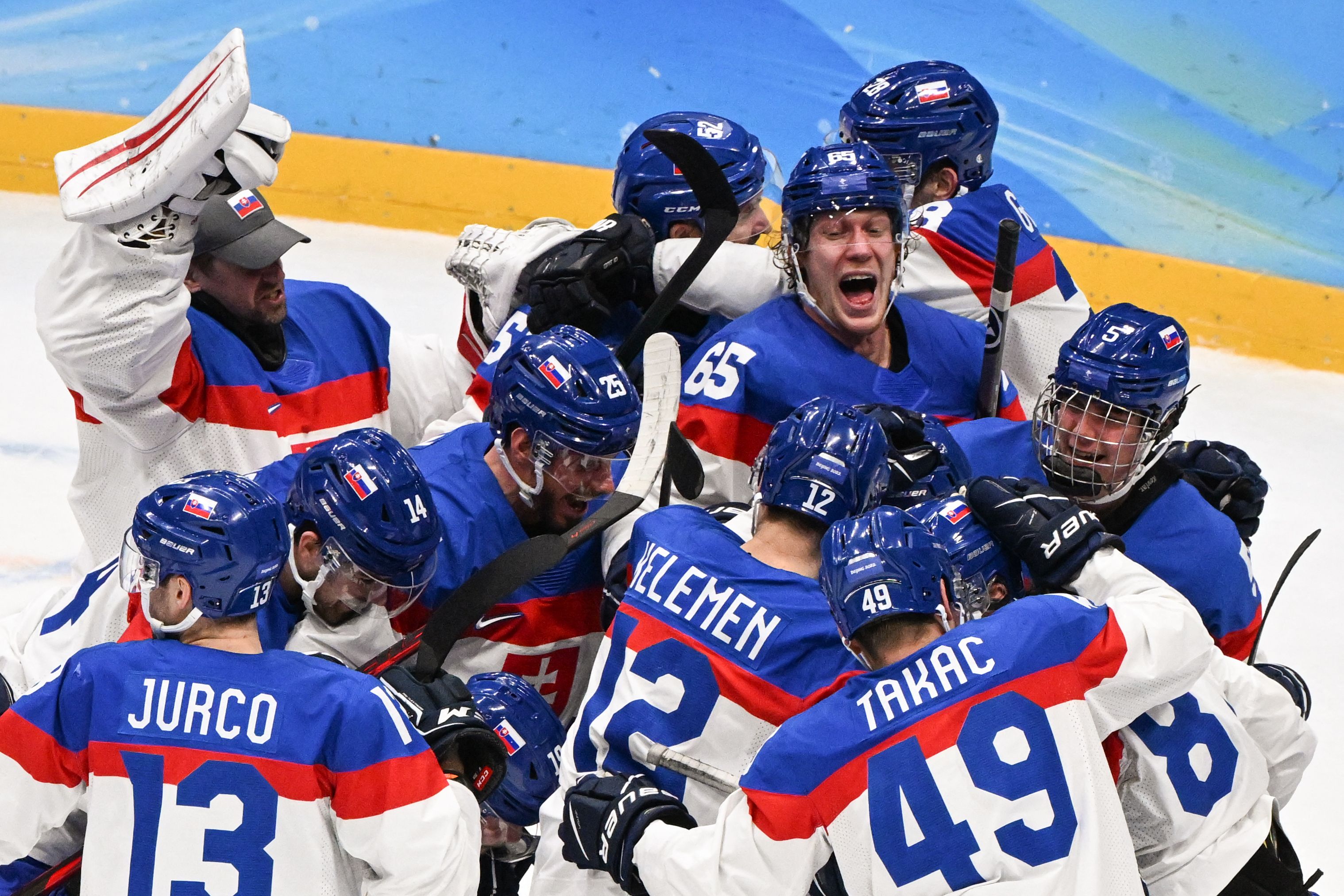 Team Slovakia celebrates after winning the men's ice hockey quarterfinal match against Team USA on Wednesday.