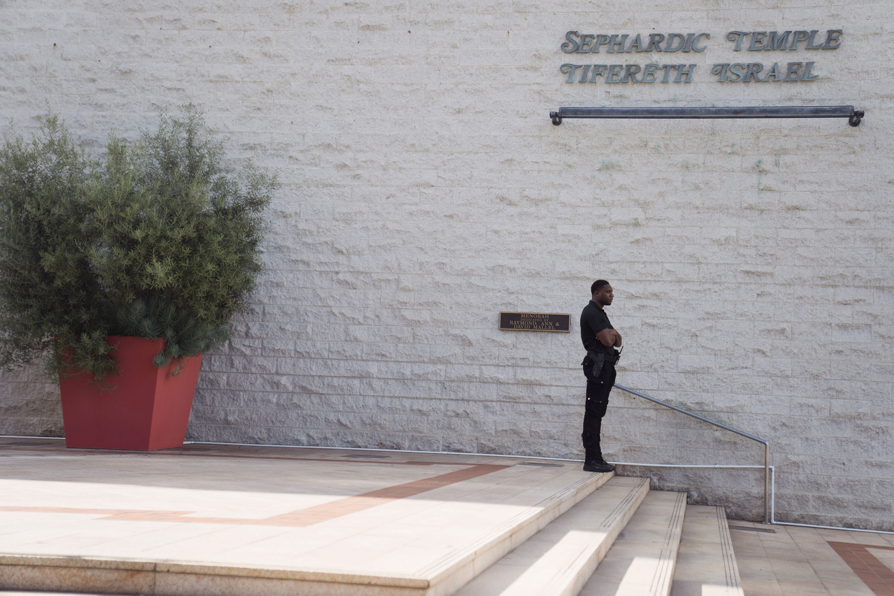 A security guard stands watch in front of Sephardic Temple Tifereth Israel synagogue on October 9, 2023, in Los Angeles, California. 