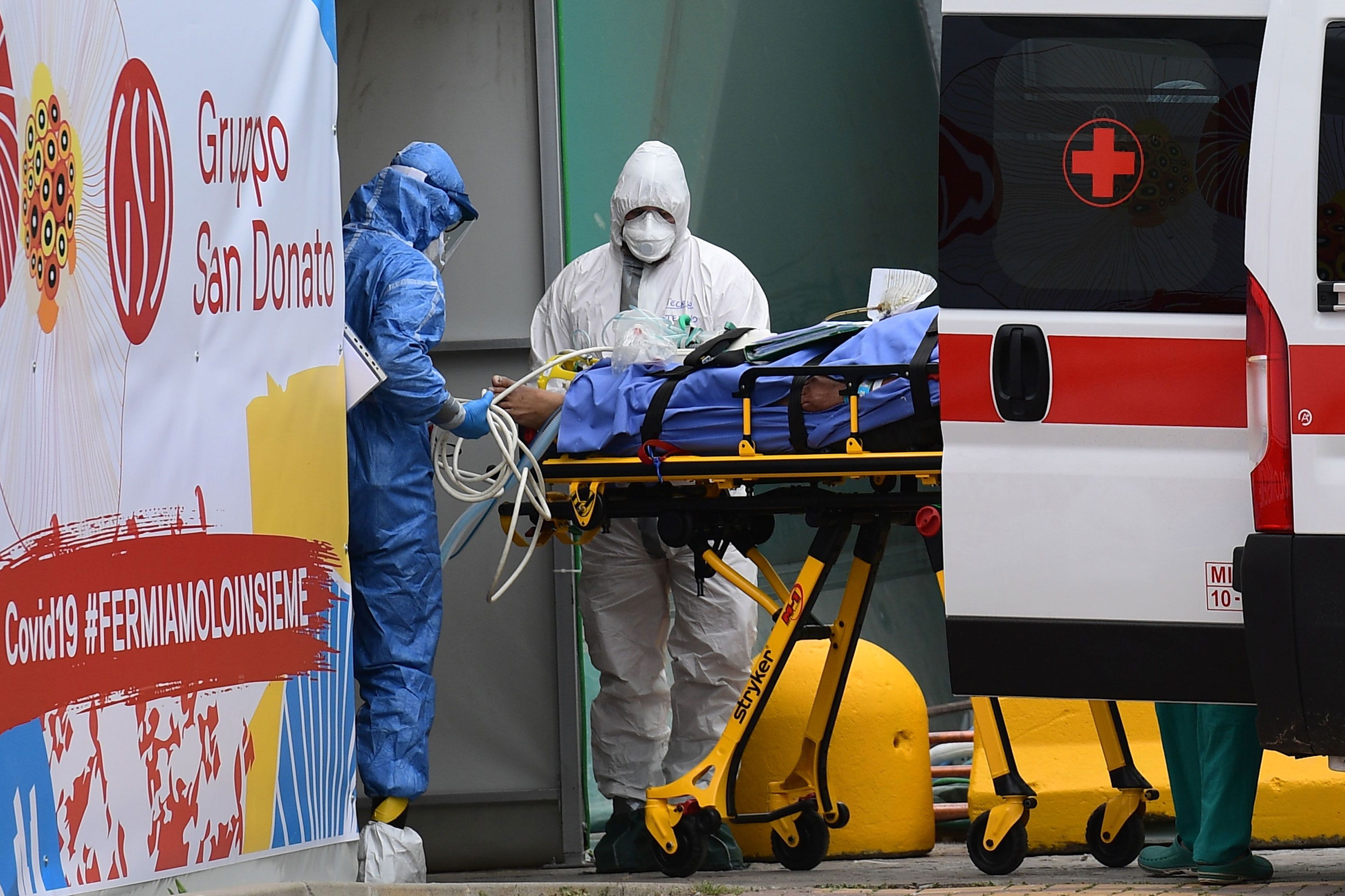 Medical workers transport a patient into an intensive care unit at San Raffaele hospital in Milan, on March 23.