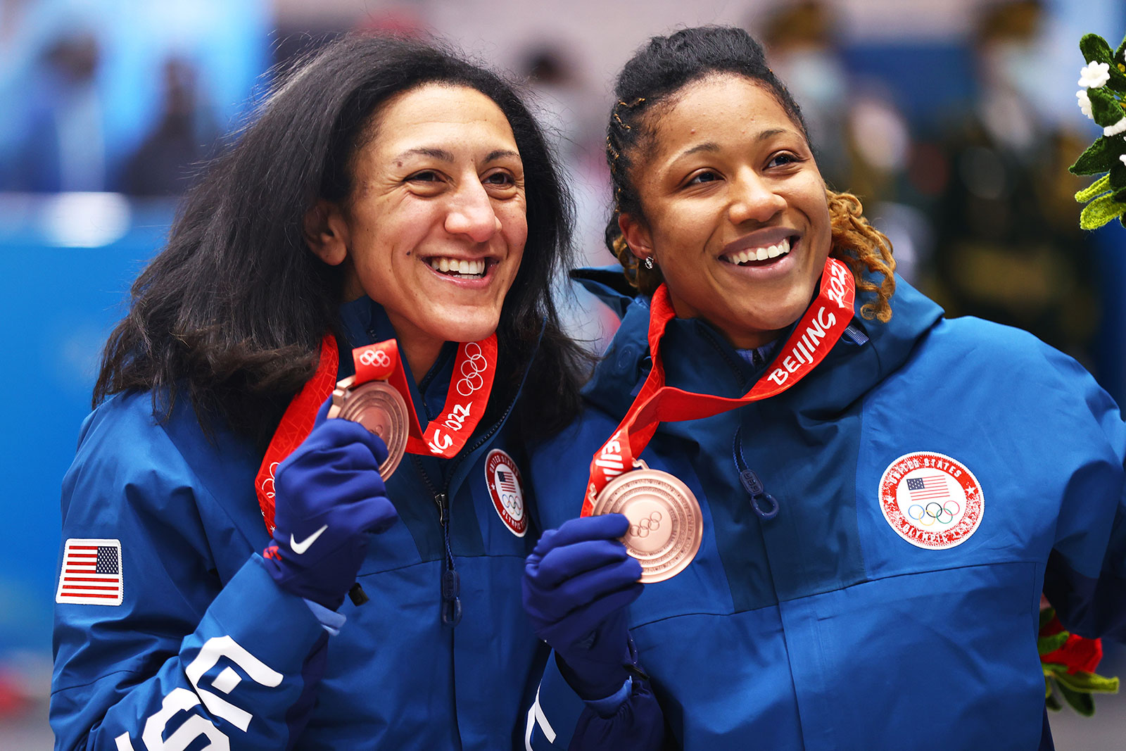American bobsledders Elana Meyers Taylor, left, and Sylvia Hoffman pose with their medals during the flower ceremony for the two-woman event on February 19.