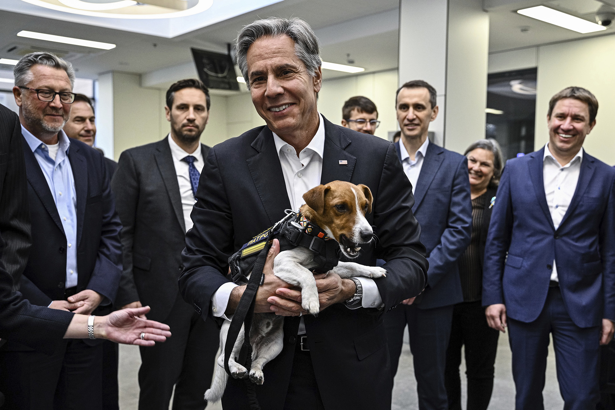 US Secretary of State Antony Blinken, center, holds a landmine sniffer dog, Jack Russell Terrier Patron during his visits to a children hospital in Kyiv, Ukraine, on September 8.