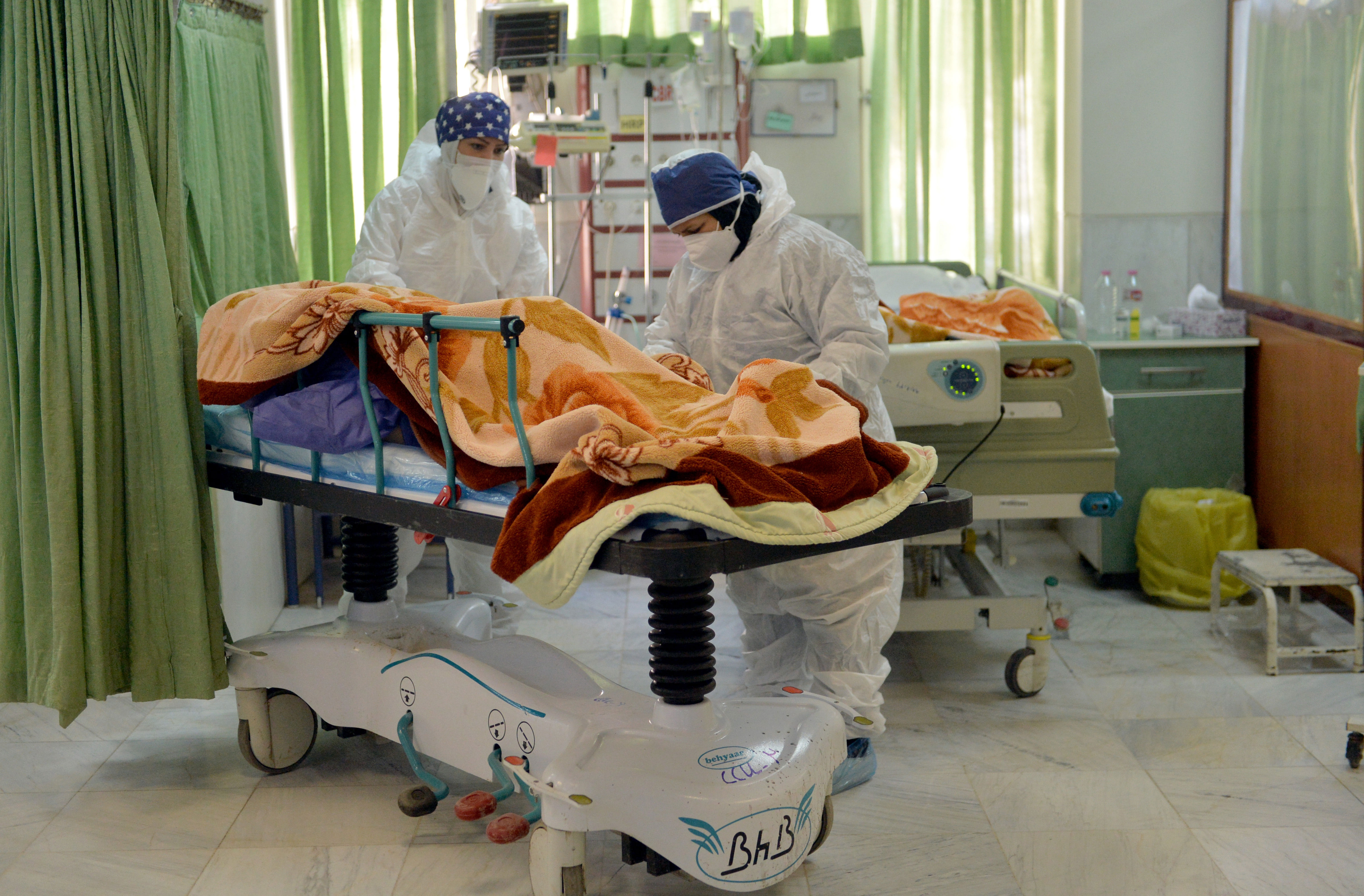 Health care staff treat a Covid-19 patient in the intensive care unit at Firouzabadi Hospital in Tehran, Iran, in December 2020.