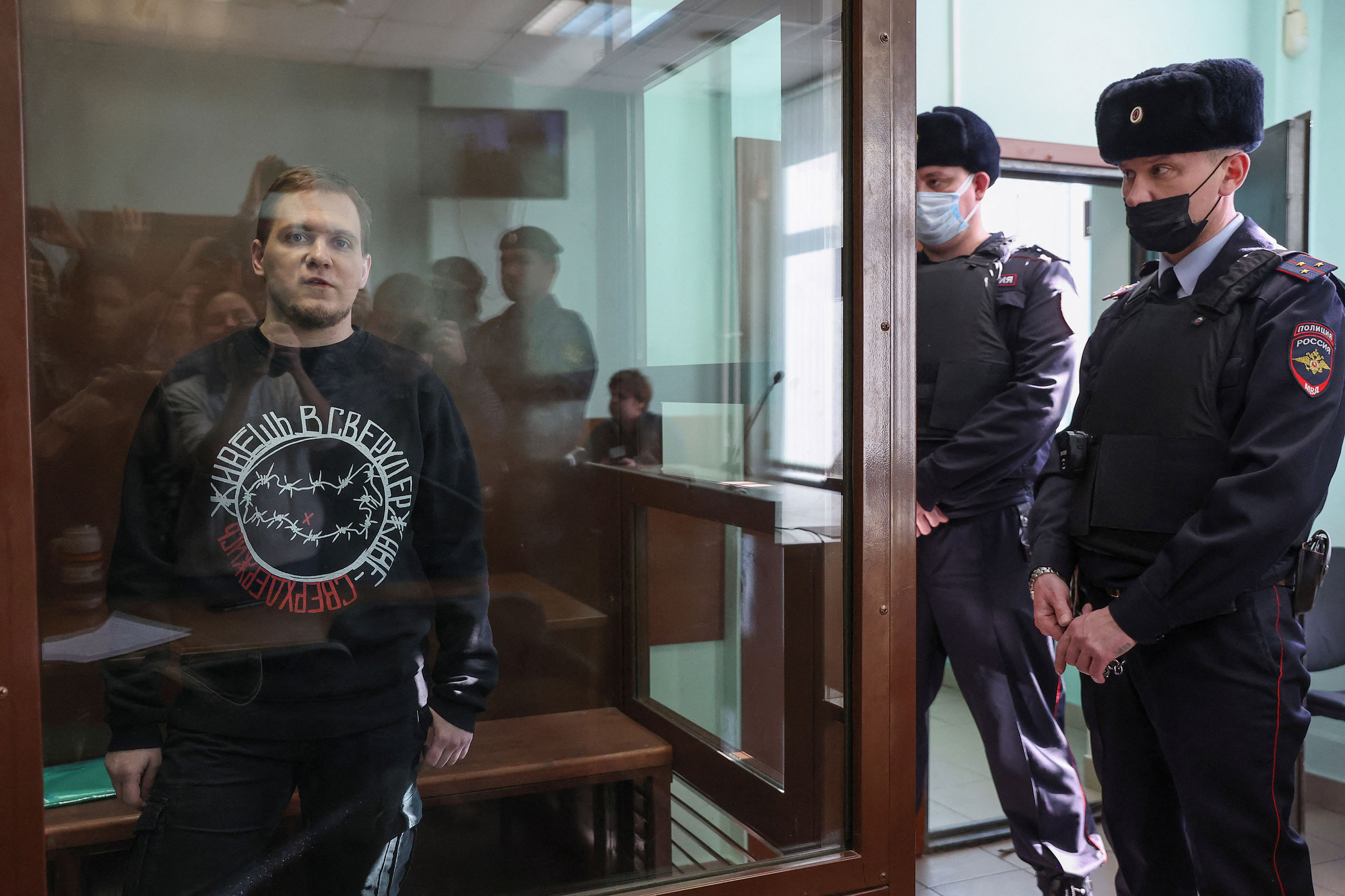 Dmitry Ivanov speaks from inside an enclosure for defendants as he attends a court hearing in Moscow on Tuesday.