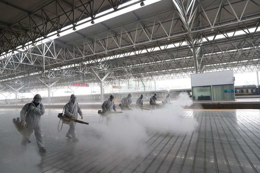 In this photo released by the state-run Xinhua news agency, firefighters conduct disinfection on the platform at Yichang East Railway Station in Yichang, in central China's Hubei Province on March 24. 