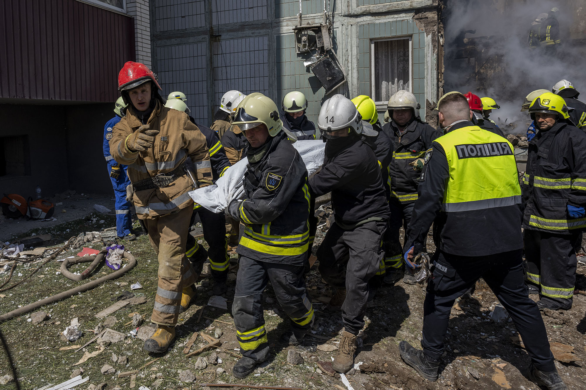 Firefighters carry a body recovered from the rubble of a residential building that was hit during a Russian attack in Uman, central Ukraine, on April 28.