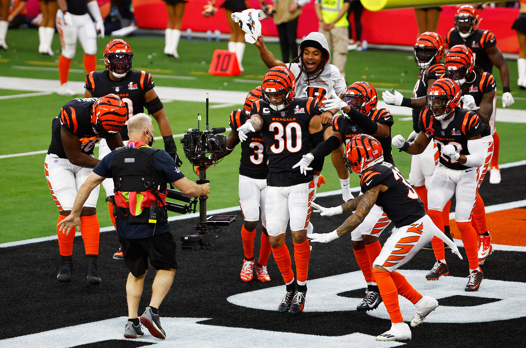 Cincinnati Bengals safety Jessie Bates III celebrates with teammates after catching an interception in the end zone.