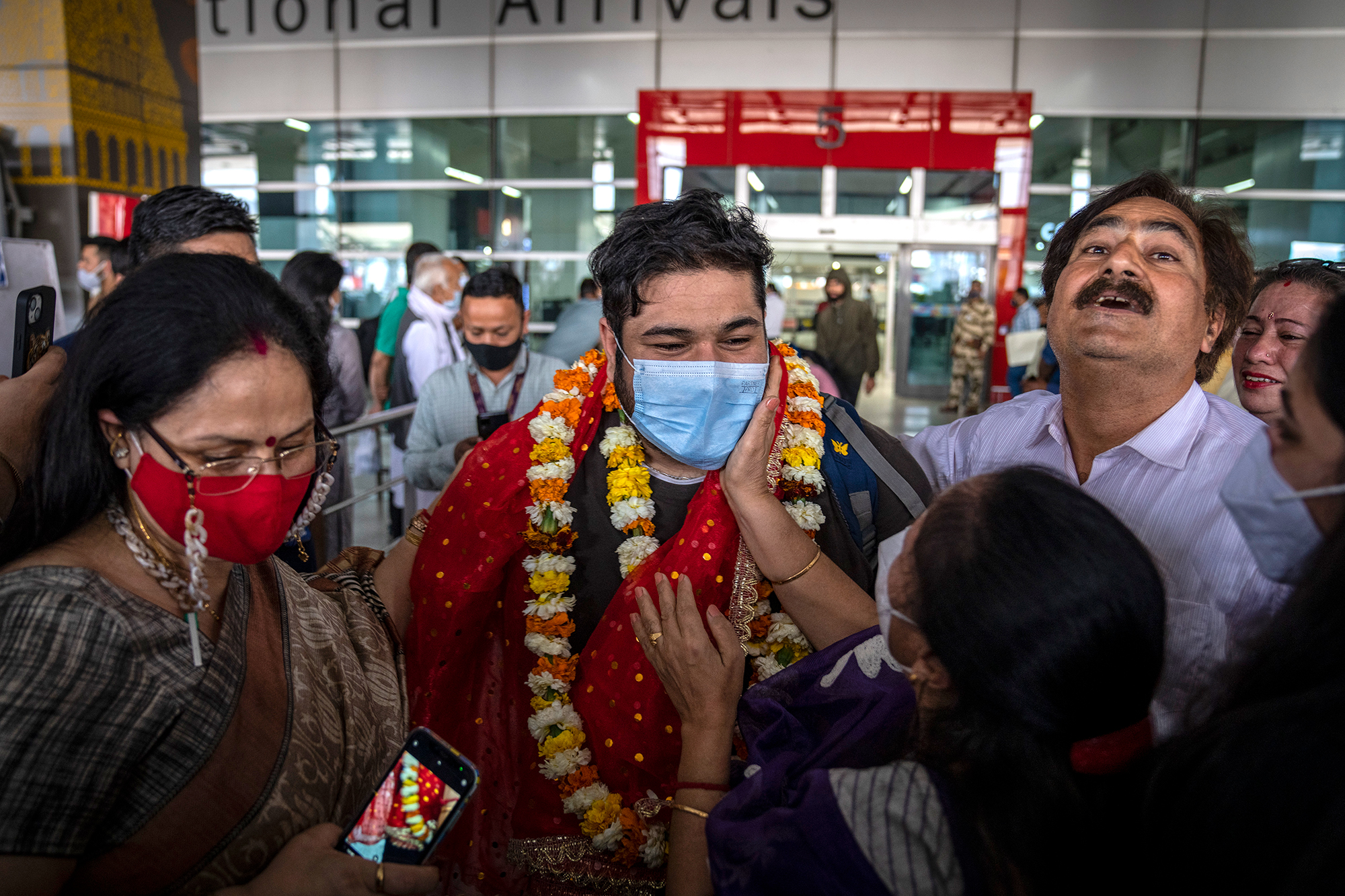 An Indian student who was evacuated from Ukraine meets his family upon arrival at the Indira Gandhi International Airport in New Delhi, India on March 11. 