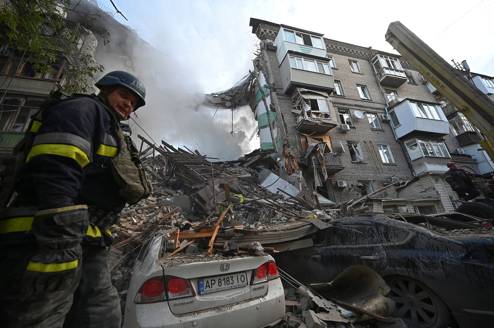 Rescuers work at a site of a residential building heavily damaged by a Russian missile strike in Zaporizhzhia, Ukraine, on October 6.
