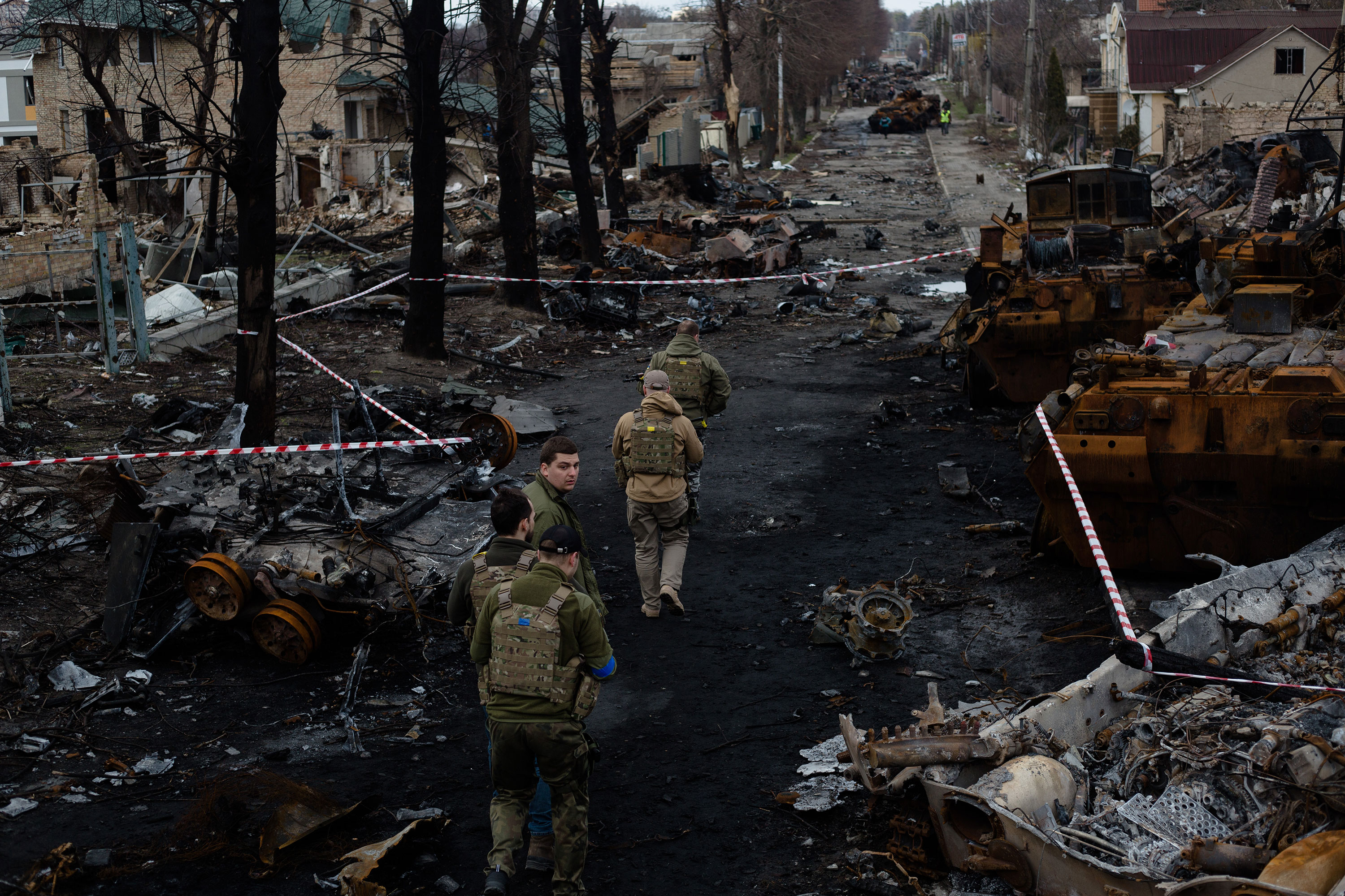 Ukrainian servicemen walk down a destroyed street in Bucha, Ukraine, on April 4.
