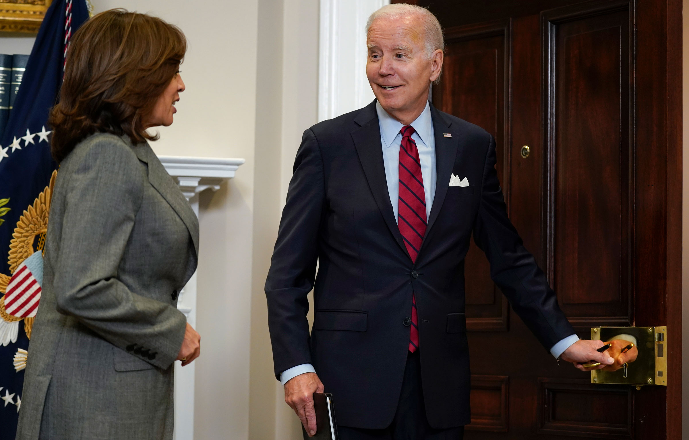 President Joe Biden turns to Vice President Kamala Harris as he responds to a reporter's question about the House speakership on Thursday.